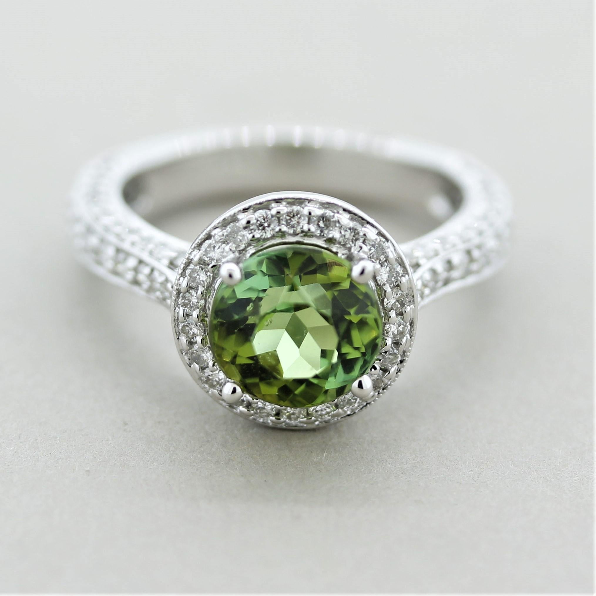 A bright and vibrant tourmaline and diamond ring. The tourmaline weighs 3.09 carats and has a bright lime-green color. It is complemented by 1.90 carats of round brilliant-cut diamonds which halo the tourmaline and blanket the rest of the ring made