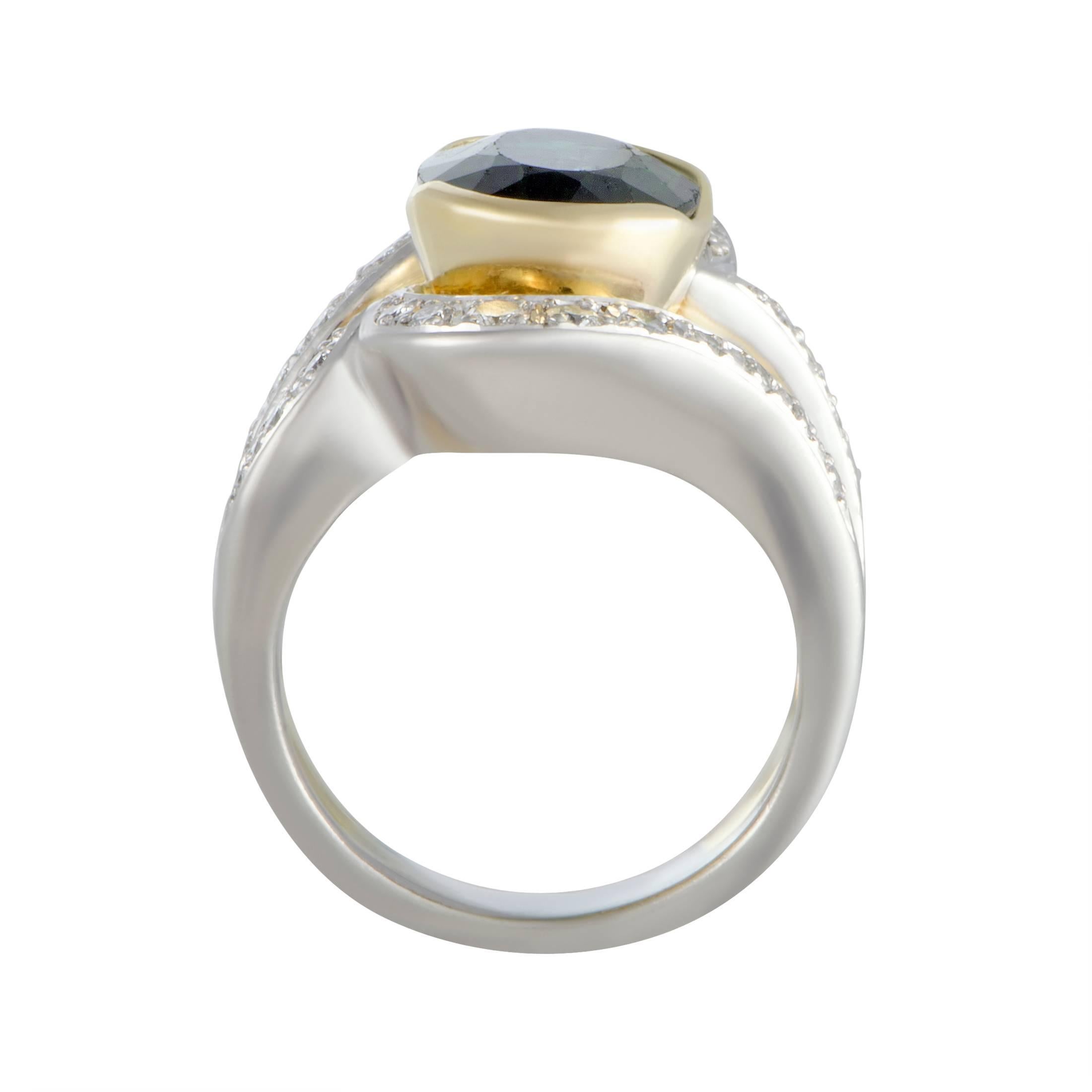 Beautifully crafted from the luxurious blend of platinum and 18K yellow gold, this spectacular ring boasts a stunningly prestigious appeal. The ring is set with 0.49 carats of diamond stones and with a striking green tourmaline that weighs 4.35