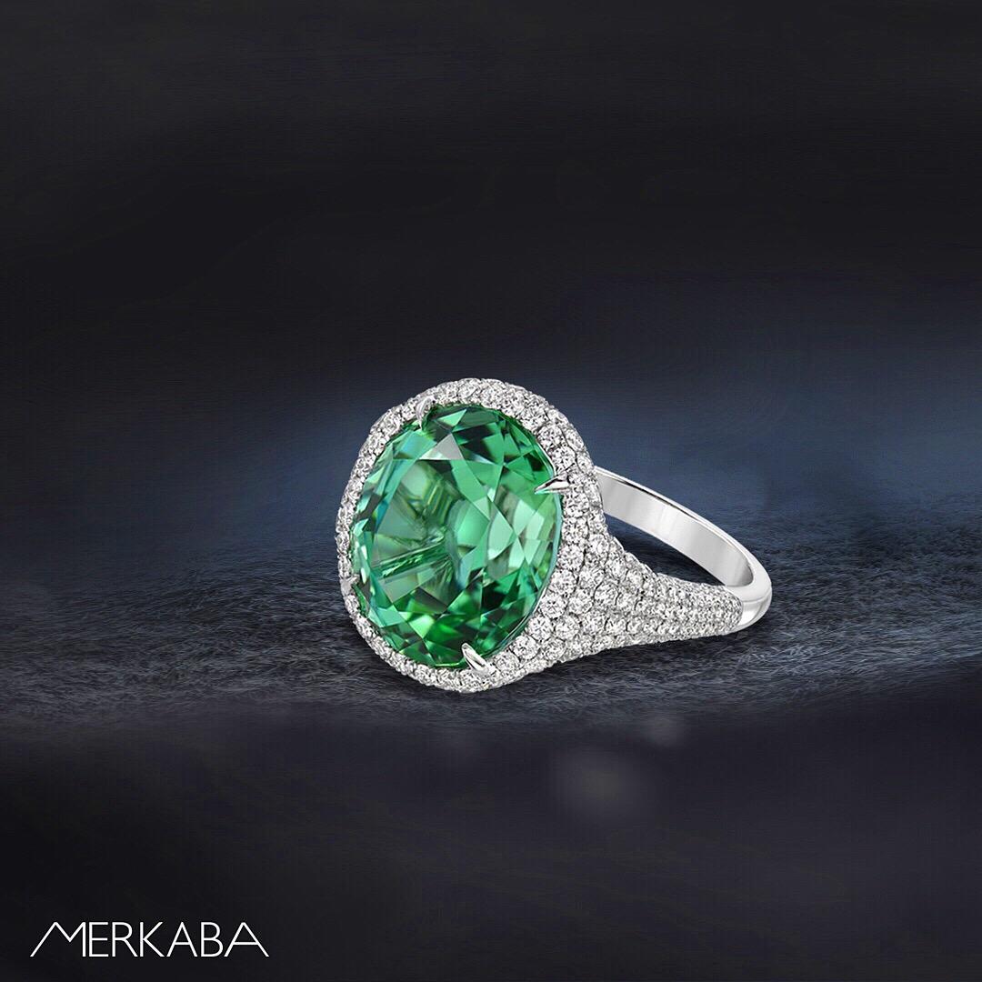 Vibrant and exotic 10.40 carat Mint Green Tourmaline oval, is hand set in this 1.58 carat round brilliant diamond, platinum ring.
Size 6.5. Resizing is complementary upon request.
Crafted by extremely skilled hands in the USA. 
Returns are accepted