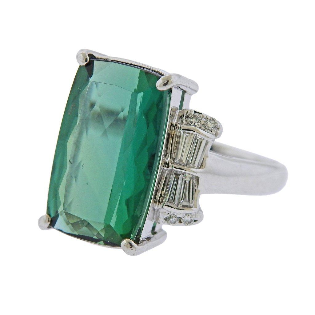 Platinum ring, featuring 10.02ct green tourmaline, set with 0.46ctw in G/VS diamonds on the side. Ring size - 7, ring top is 18mm wide. Weight is 11.4 grams. Marked Pt900, 1002, D0.43.