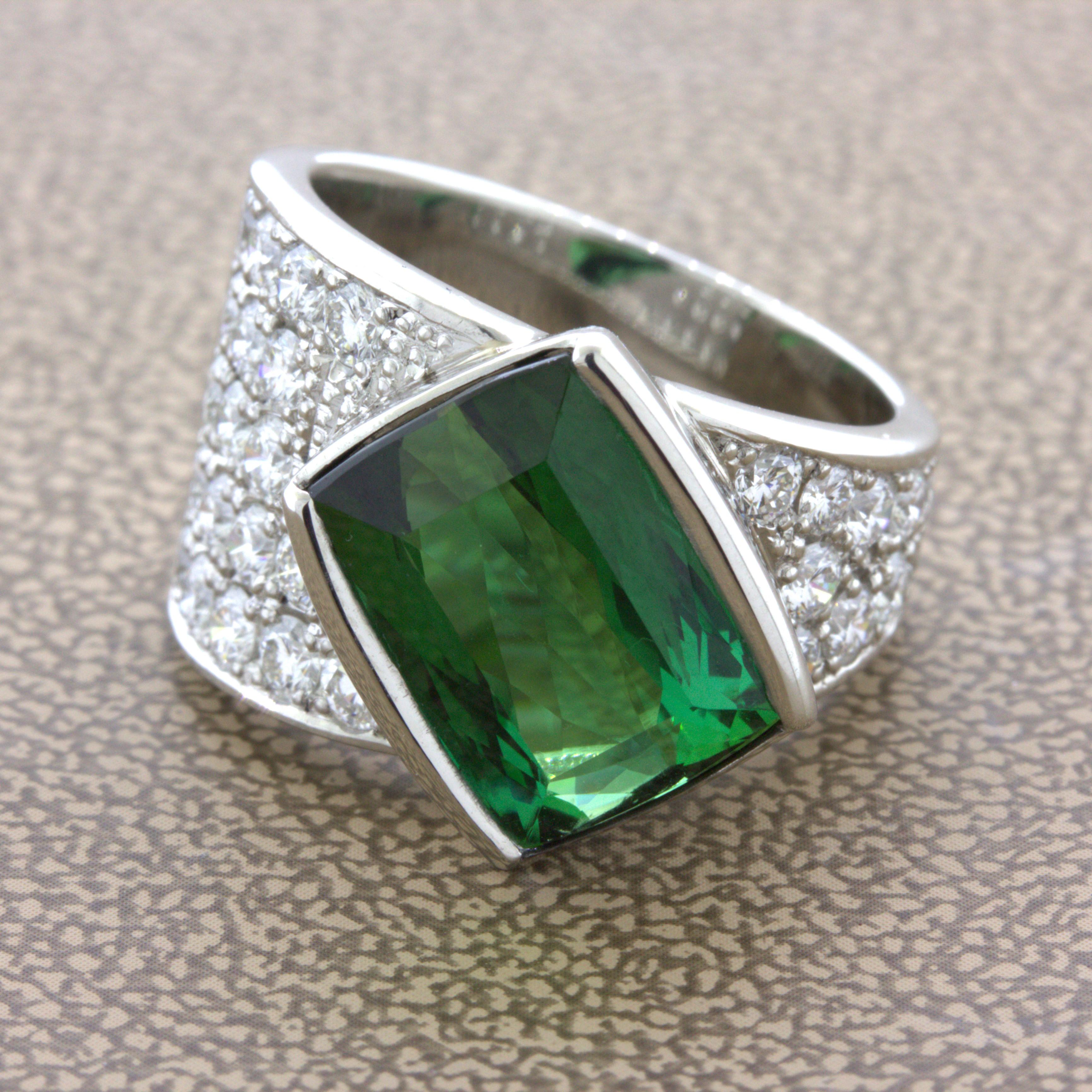 A sweet and fine tourmaline takes center stage! It has a lovely vibrant bluish-green color that radiates in the light and weighs 5.44 carats. It is complemented by 1.35 carats of round brilliant-cut diamonds set on its sides. Hand-fabricated in