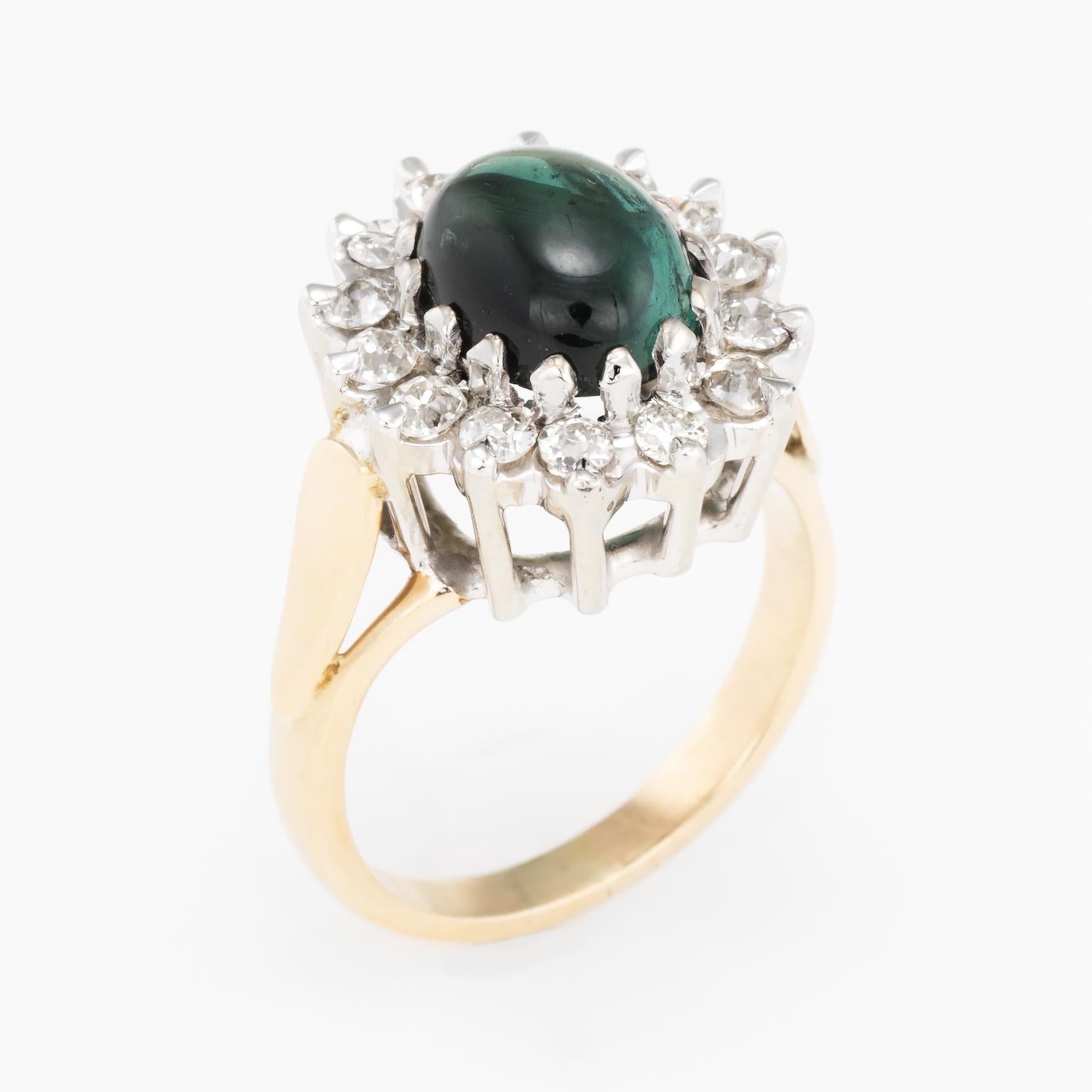 Elegant vintage princess cocktail ring, crafted in 14 karat yellow gold. 

Cabochon cut green tourmaline measures 9mm x 7mm (estimated at 2.25 carats), accented with an estimated 0.56 carats of old mine cut diamonds (estimated at H color and SI1-2
