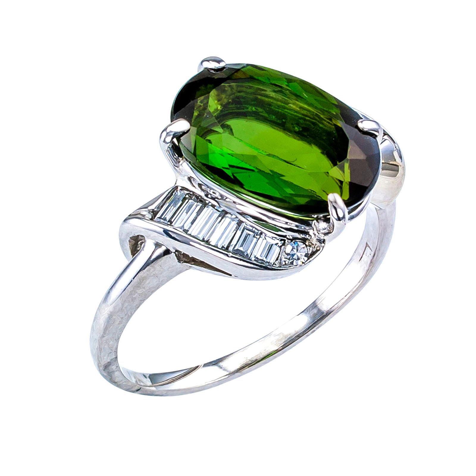 Green tourmaline and diamond white gold ring circa 1950.

SPECIFICATIONS; A7869

DIAMONDS: twelve baguette and two single-cut diamonds totaling approximately 0.30 carat, approximately H color and VS clarity.

GEMSTONES: one oval-shaped, faceted