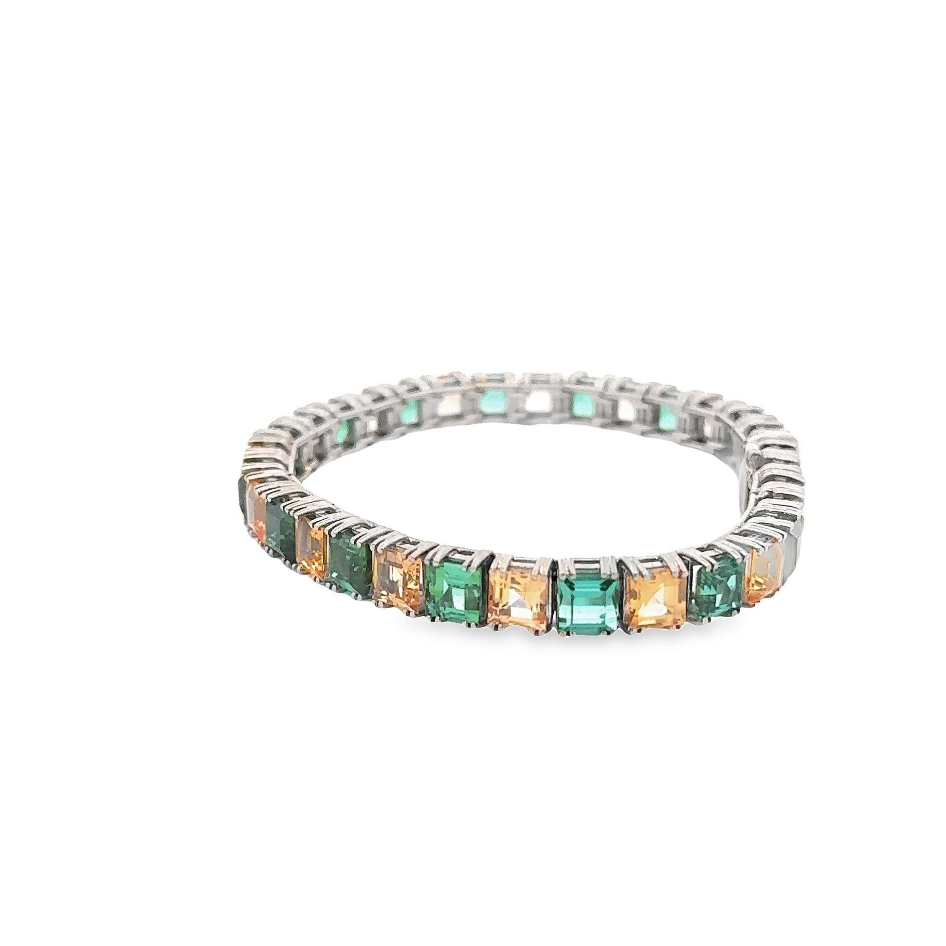 A chic line bracelet featuring interchanging square-shape tourmaline and topaz! The tourmaline have a soft and clean blueish-green color while the topaz have a golden orange-yellow color which complement each other. They are set in 18k white gold in