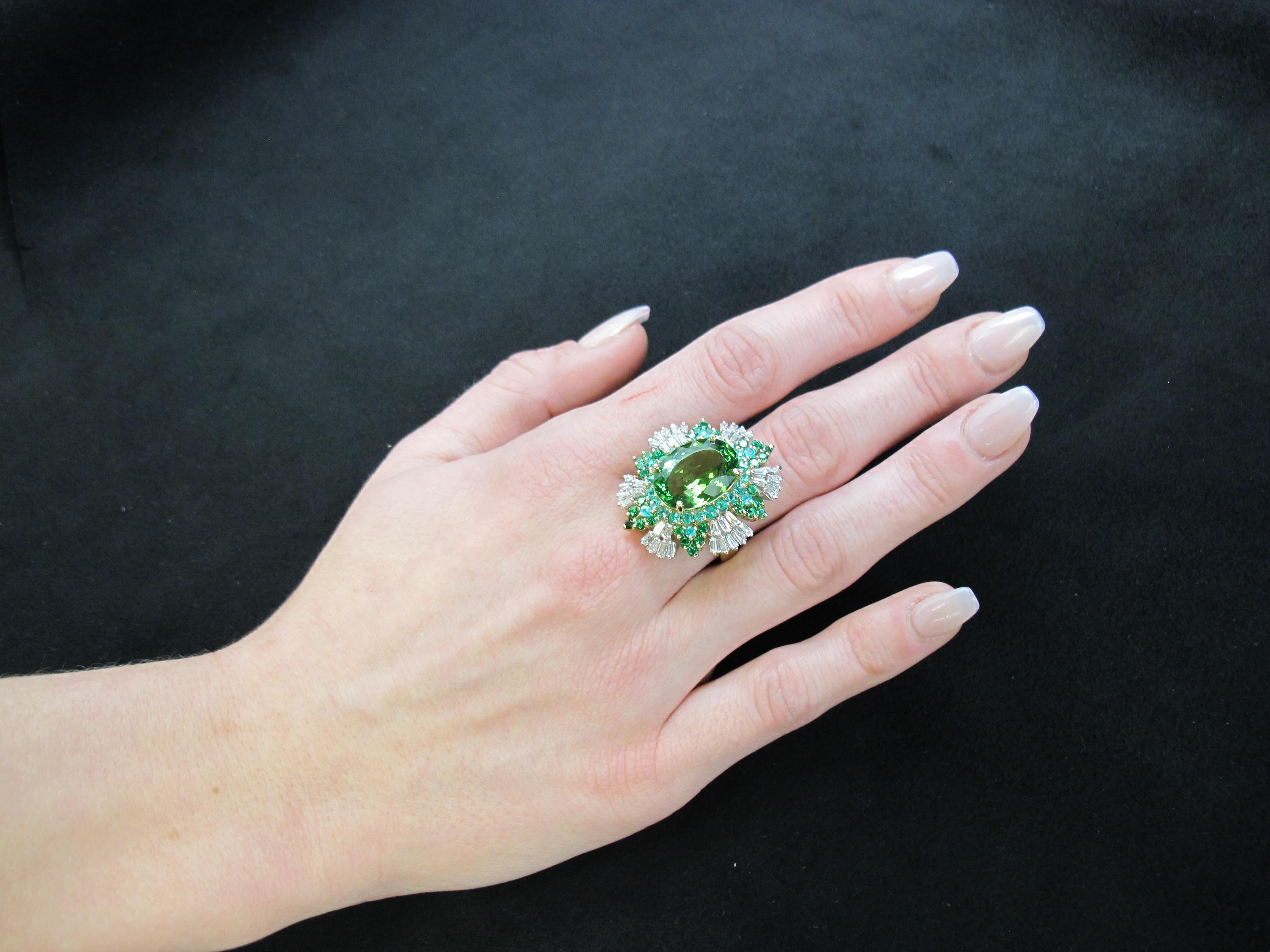 Bursting with color, this vibrant collection of stones is set with boldness in mind!  A large (16x11.80x7.30m/9.50cts) oval green tourmaline is featured in this ring which is accompanied by Gemological Institute of America certificate # 5172138063. 