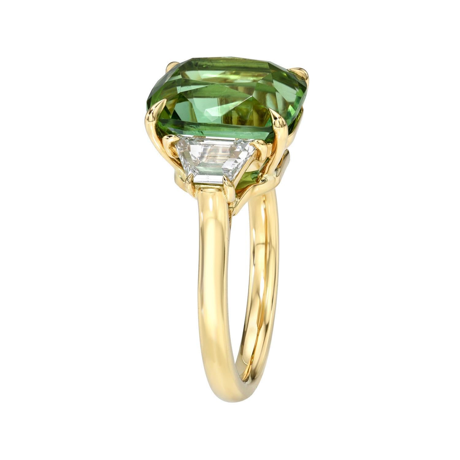 Marvelous 6.04 carat Apple Green Tourmaline oval 18K yellow gold three stone ring, decorated with a pair of 0.75 carats, E color/VS2-SI1 clarity, trapezoid diamonds.
Size 6. Re-sizing is complimentary upon request.
Returns are accepted and paid by