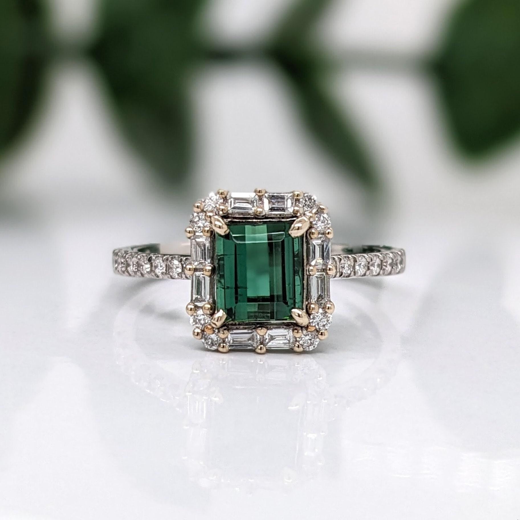 This beautiful art deco ring features a vibrant green tourmaline set in 14k white gold with round and baguette diamond accents. A gorgeous deep green gemstone that rivals in looks with the finest emeralds in color and clarity, but for a fraction of