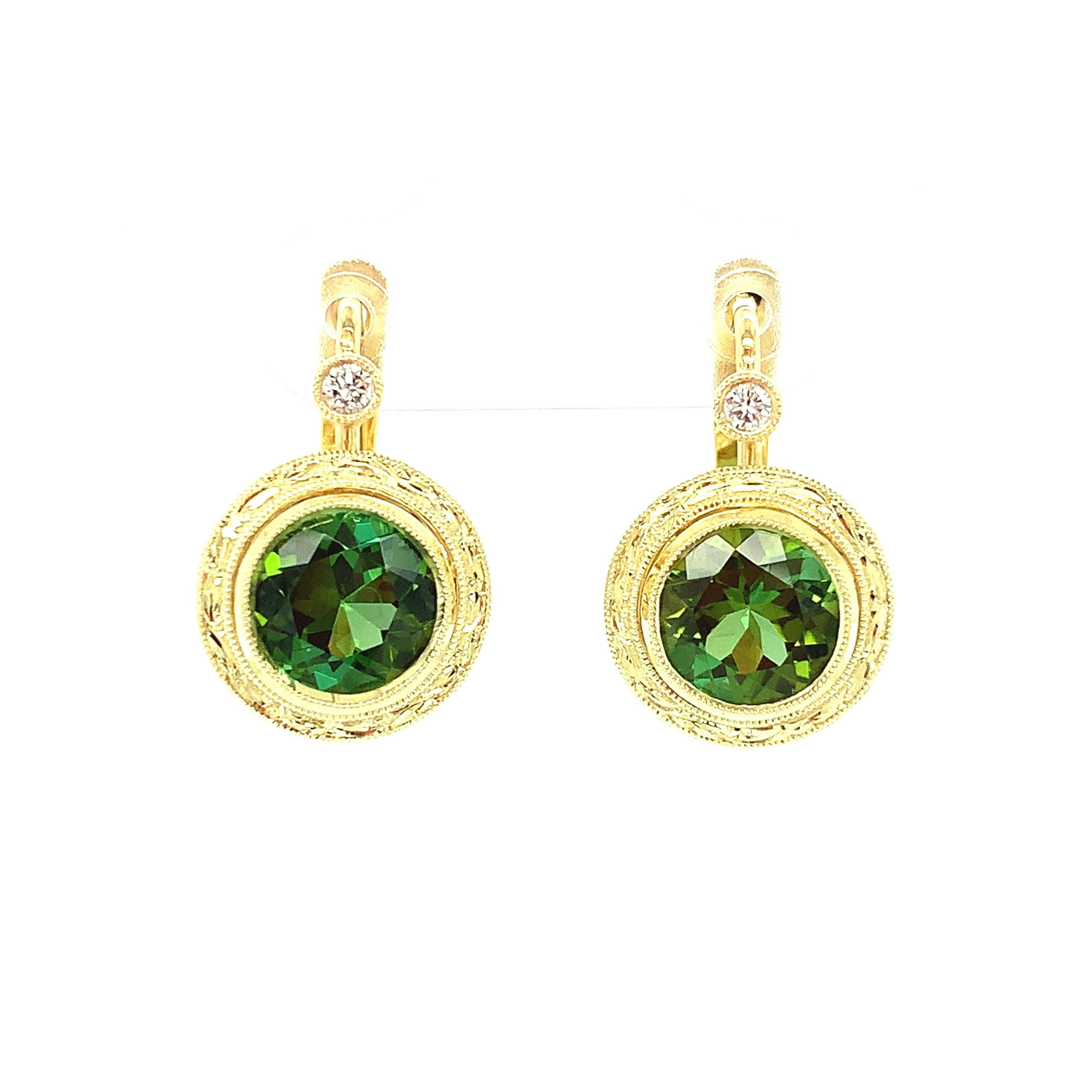 Large, brilliant, grass-green tourmalines are featured in these lovely 18k yellow gold, hand engraved drop earrings. Two brilliant diamonds provide add sparkle, and the lever backs keep them perfectly positioned. These earrings are a perfect 