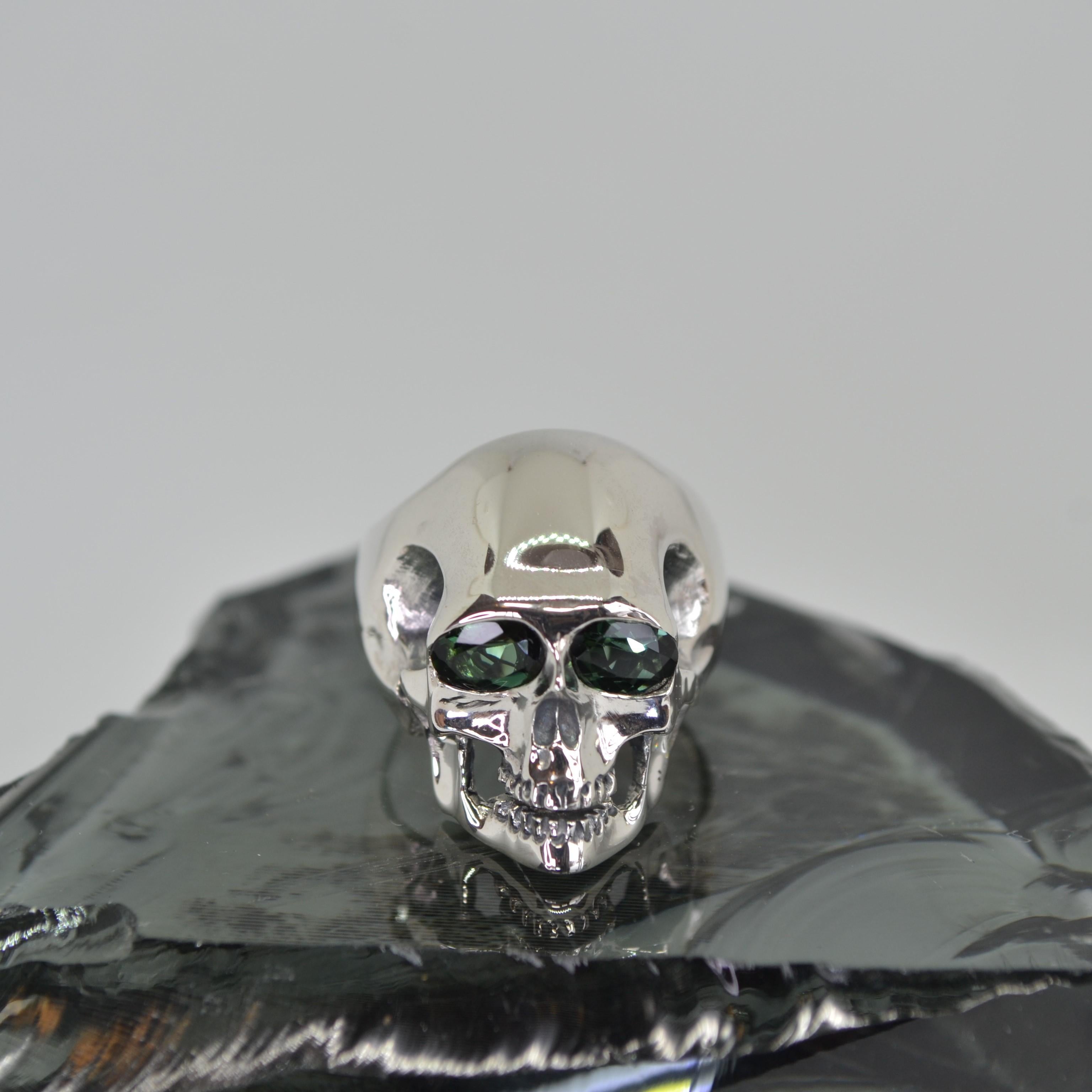 Green Tourmaline Silver Skull Ring

Set with green tourmaline 6x4mm eyes

Made in 925 sterling silver

Fully polished solid silver ring

Handcrafted crafted design
An alternative style green tourmaline ring.

Total weight 12.5g

Size K on the UK