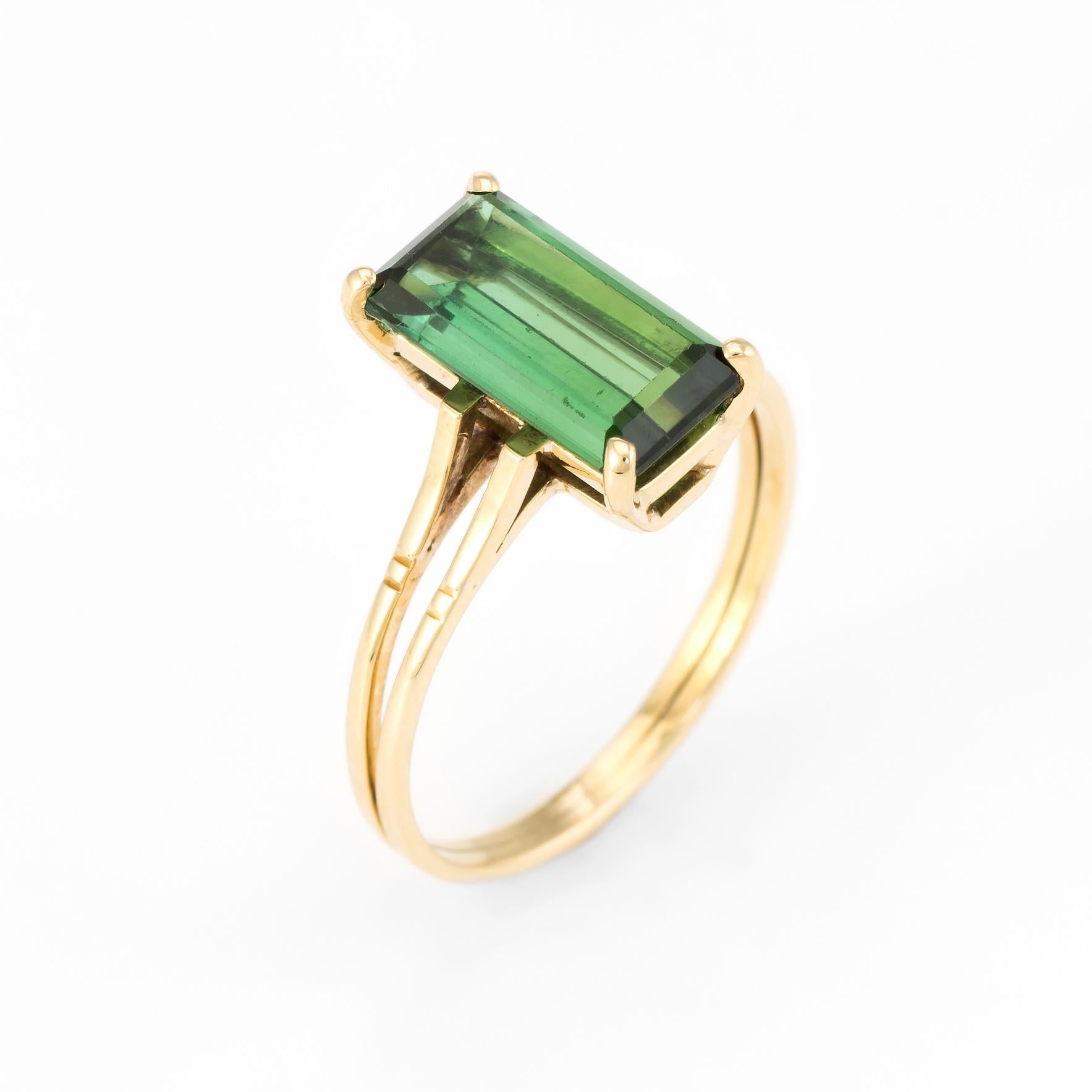 Elegant vintage small cocktail ring, crafted in 18 karat yellow gold. 

Emerald cut green tourmaline measures 11mm x 5.75mm (estimated at 2.50 carats). The tourmaline is in excellent condition and free of cracks or chips.   

The ring is in