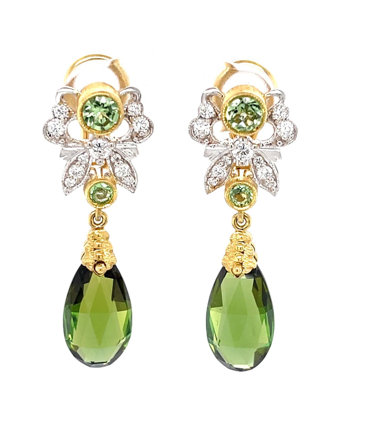 These pretty dangle earrings feature gem-quality green tourmalines that have been faceted as elegant pendeloques! Set in 18k yellow gold, these feminine drops are so elegant and sophisticated, set with bright, sparkling green tsavorite garnets and