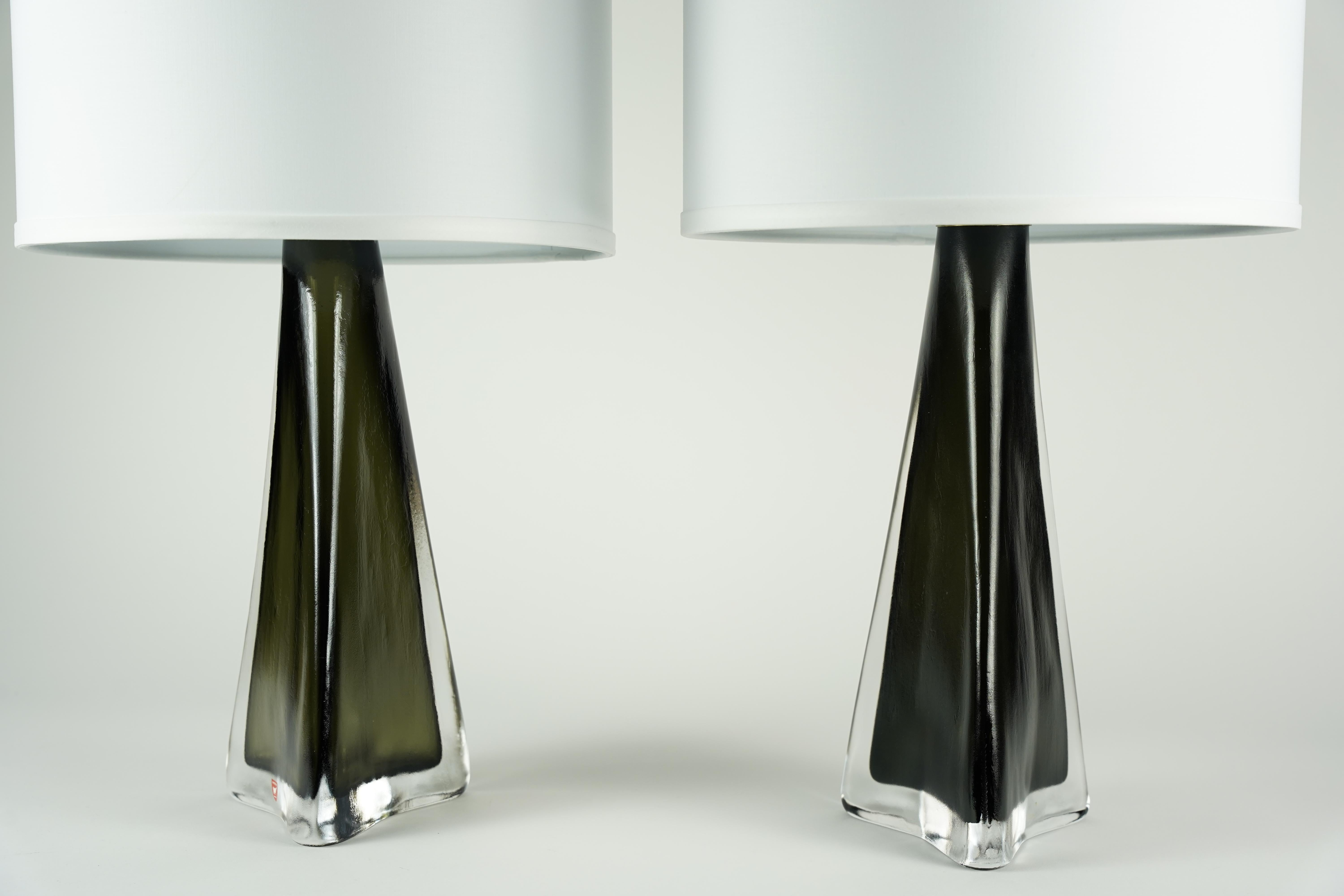 Paire de lampes en cristal vert enveloppées d'une couche de verre clair dépoli avec un raccord en laiton, par Carl Fagerlund pour Orrefors, 1960.


Les abat-jour ne sont pas inclus.