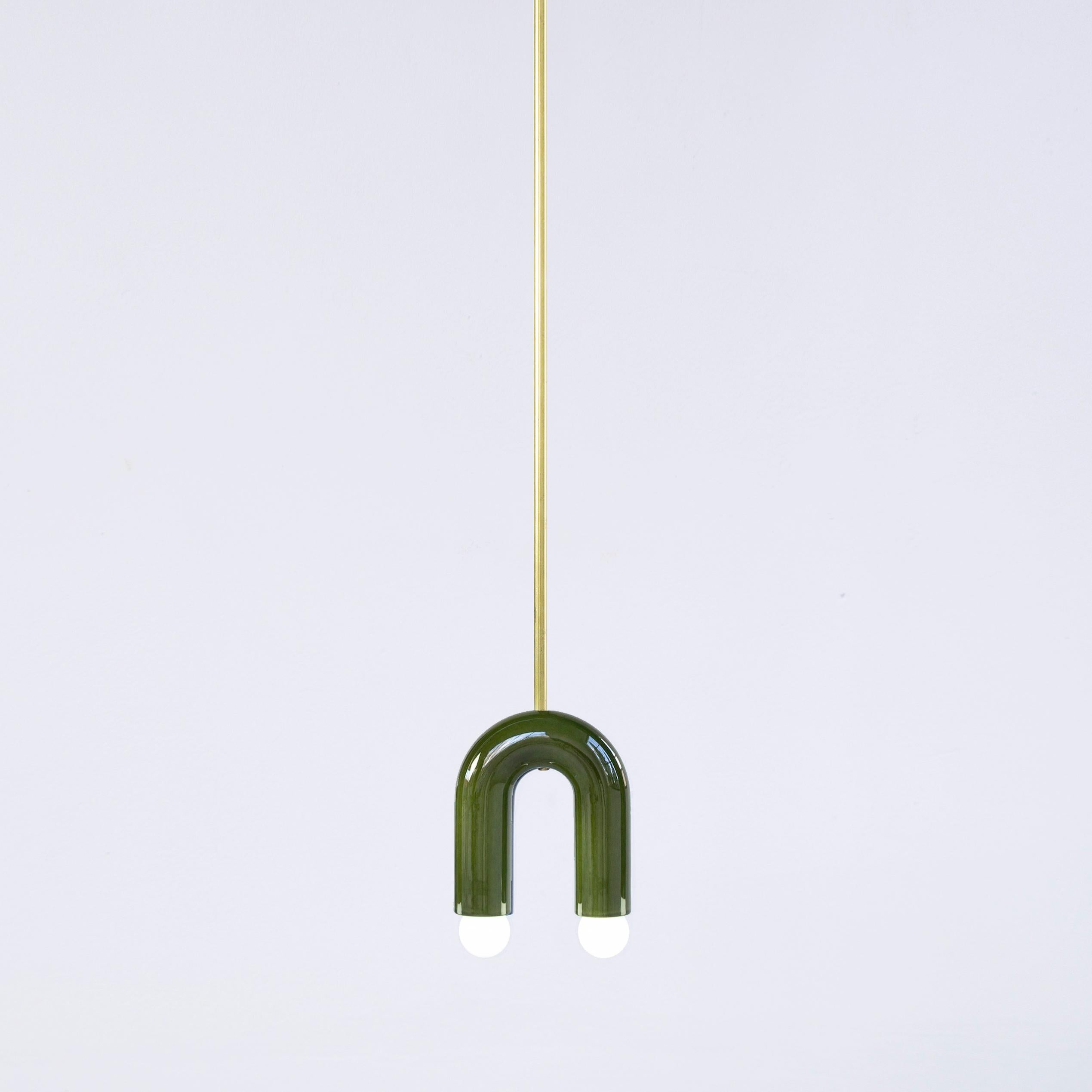 Green TRN A1 pendant lamp by Pani Jurek
Dimensions: D 5 x W 15 x H 18 cm 
Material: ceramic and brass.
Available in other colors.
Lamps from the TRN collection hang on a metal tube, not on a cable. This allows the lamp to be mounted in a specific