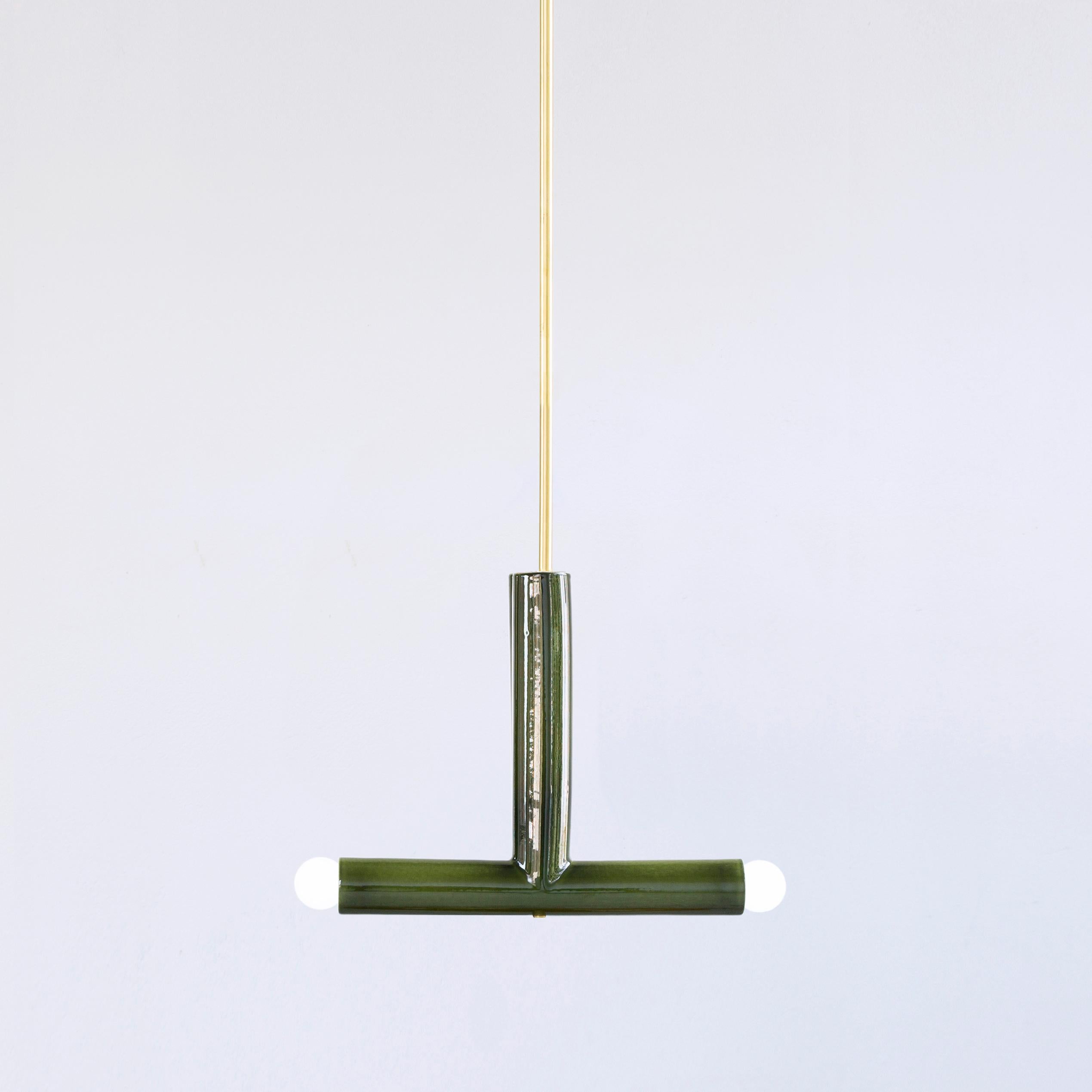 Green TRN B2 pendant lamp by Pani Jurek
Dimensions: D 5 x W 35 x H 30 cm 
Material: Hand glazed ceramic.
Available in other colors.
Lamps from the TRN collection hang on a metal tube, not on a cable. This allows the lamp to be mounted in a specific