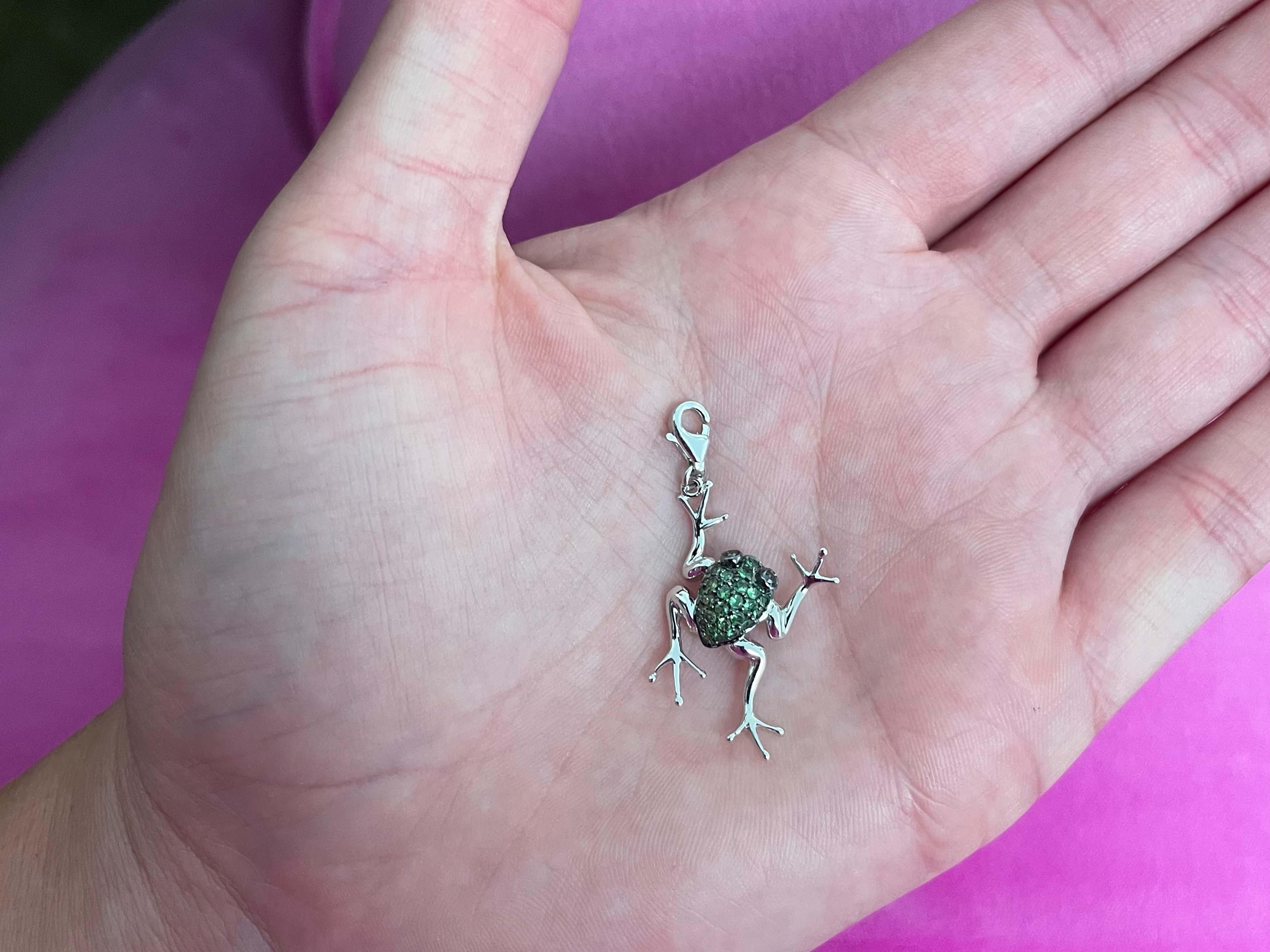 Green Tsavorite & Black Diamond Frog Pendant Charm in 14K White Gold. The body is made with green tsavorite and the eyes are made with black diamonds. The body of the frog is black rhodeum plated. This pendant charm is beautifully crafted in 14k