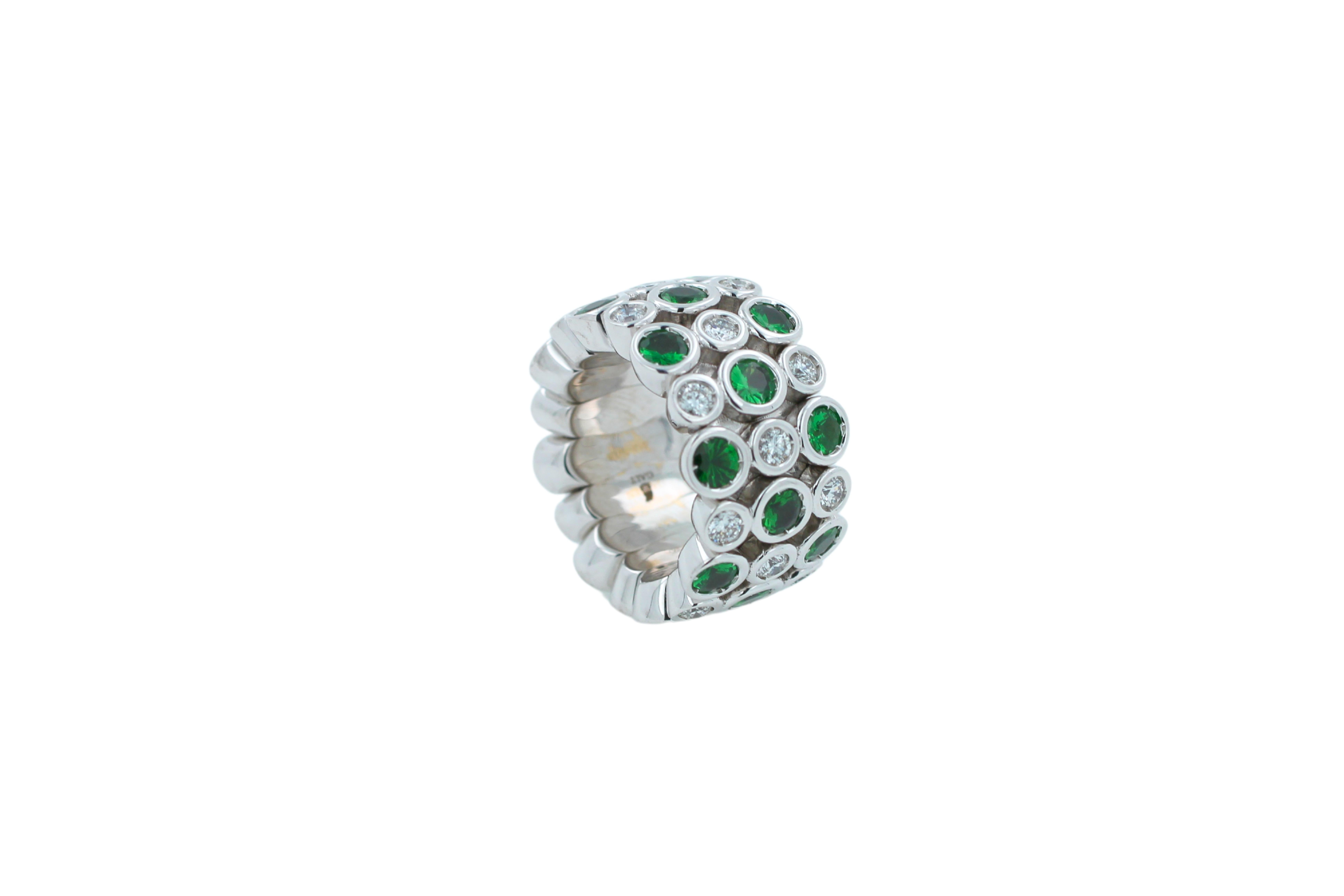 Multi Color Green Eternity Patterns Ring

Green Tsavorite Diamond Flexible Bezel Eternity Band 18 Karat White Gold Ring

Jewels inspired by the colourful Art Deco movement. Lively designs and colorful Interpretations in a triple row eternity band