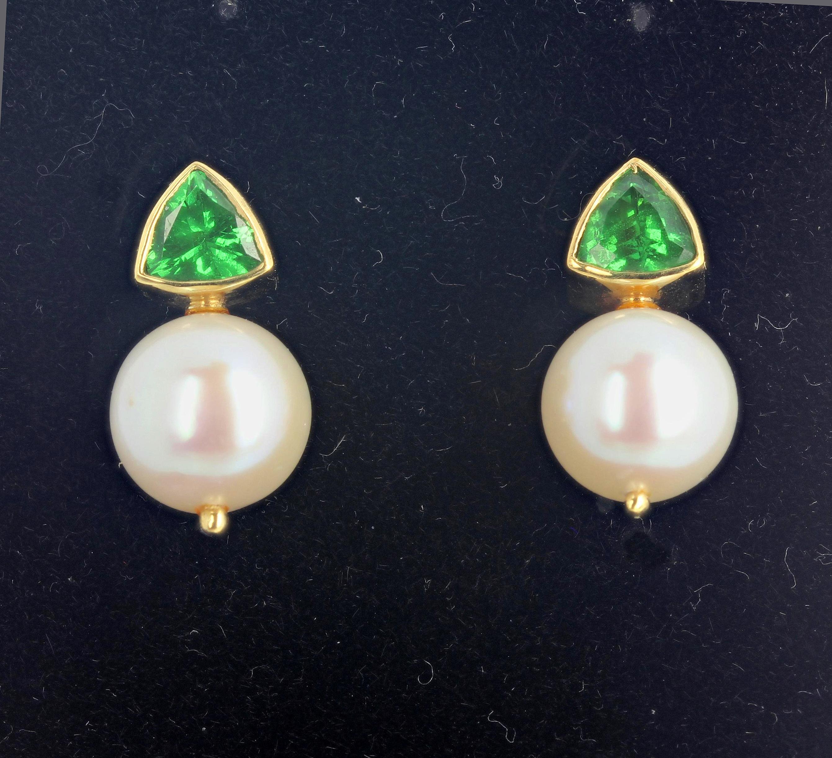 Beautiful glittering green rare natural real Tsavorites (more or less 1.25 carats each) are enhanced by lovely round real Cultured Pearls set in 18 KT yellow gold stud earrings.  They hang approximately 18 mm long.  If you wish faster delivery on