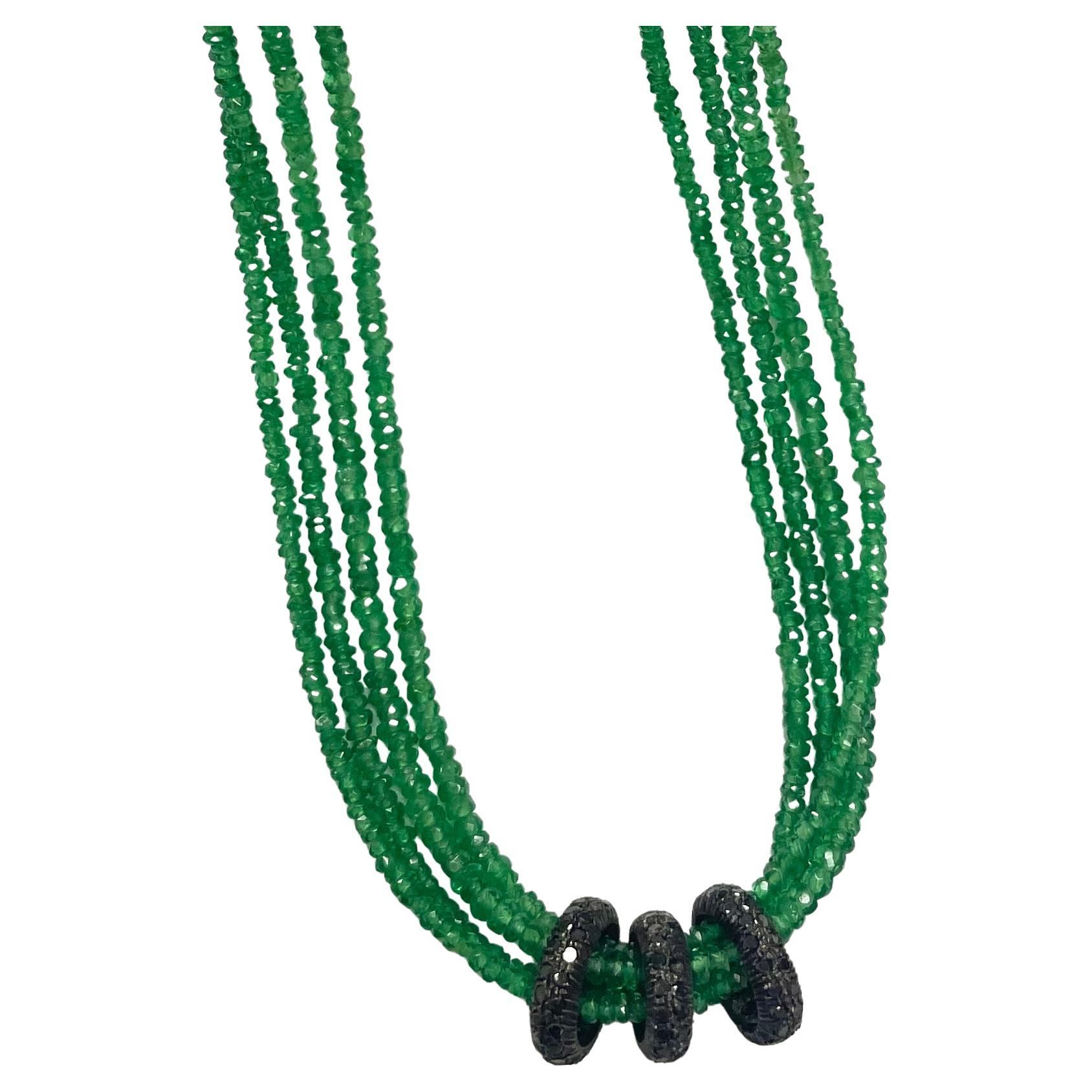 Description
Vibrant green, rare Tsavorite Garnet faceted rondelles, 4 strand necklace, embellished with 3 black pave diamond floating oval rings. 
Item # N3817. 
Check out matching Earrings (see photo) Item # E3114 ($7,550)
We also suggest a