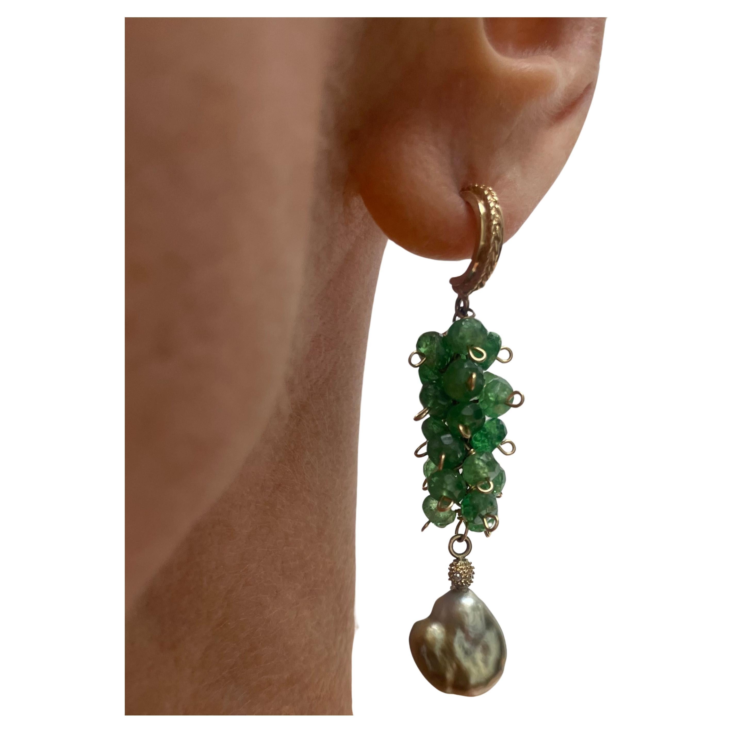 Description
Double rarity! Tsavorite, the rarest of Garnets, whimsically clustered and perfectly arranged to complement the stunning and equally rare natural green Tahitian Keshi pearls accented with a pave diamond ball. How rare do you feel?
Item #