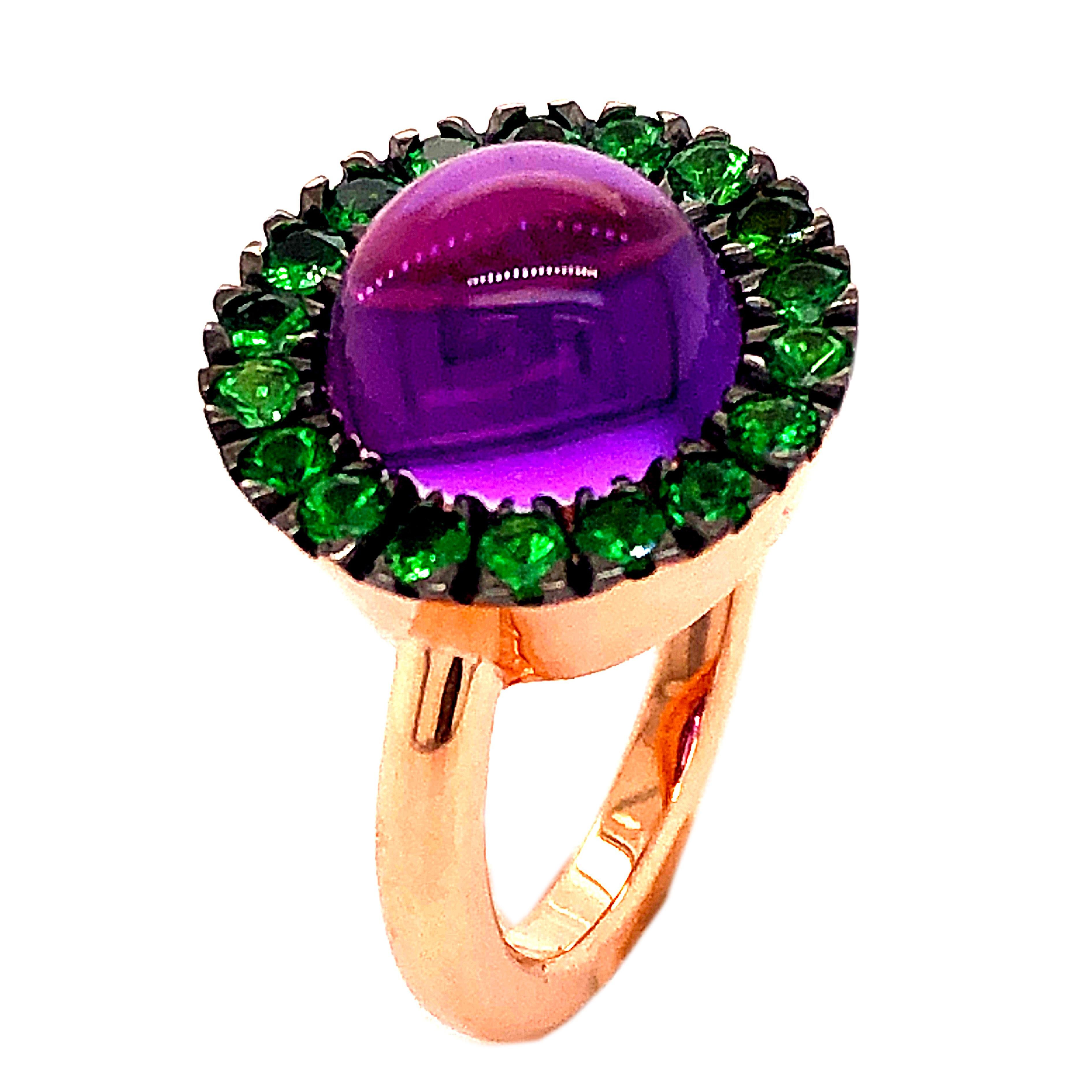 Chic, Unique yet Timeless Contemporary Cocktail Ring featuring a Natural 3.9Kt Amethyst Round Cabochon surrounded by 1.09Kt Natural Vivid green Tsavorite in an elegant Rose Gold Setting: a Stunning, Magical Piece.
In our smart Burgundy Leather Box