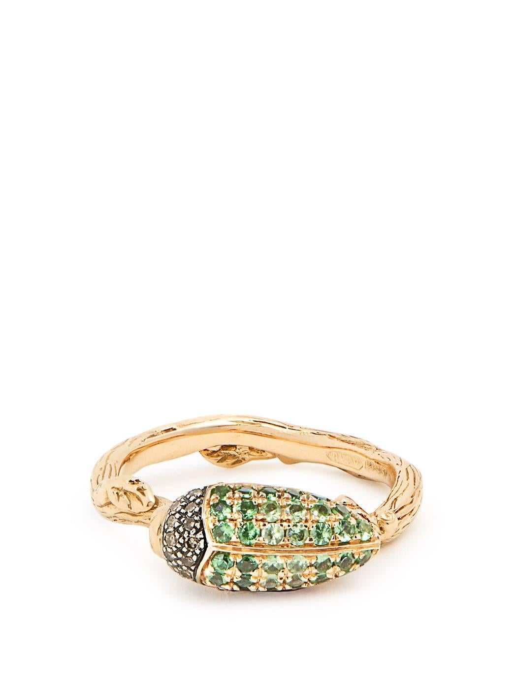 The Tsavorite Scarab Stackable Ring is made of 18k Yellow Gold and Sterling Silver, set with a vibrant green gradient of Tsavorites, and brown diamonds. This ring is from Bibi van der Velden's iconic Scarab Collection and looks elegant when worn