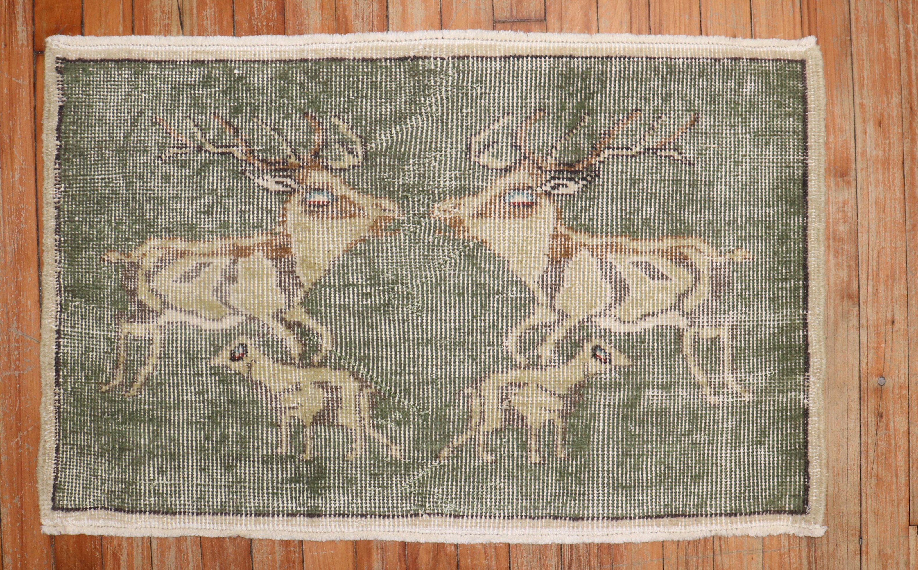 One-of-a-kind hand-knotted Turkish Anatolian rug with 2 deers and 2 other animals on a green ground

Measures: 1'9” x 2'3”.


