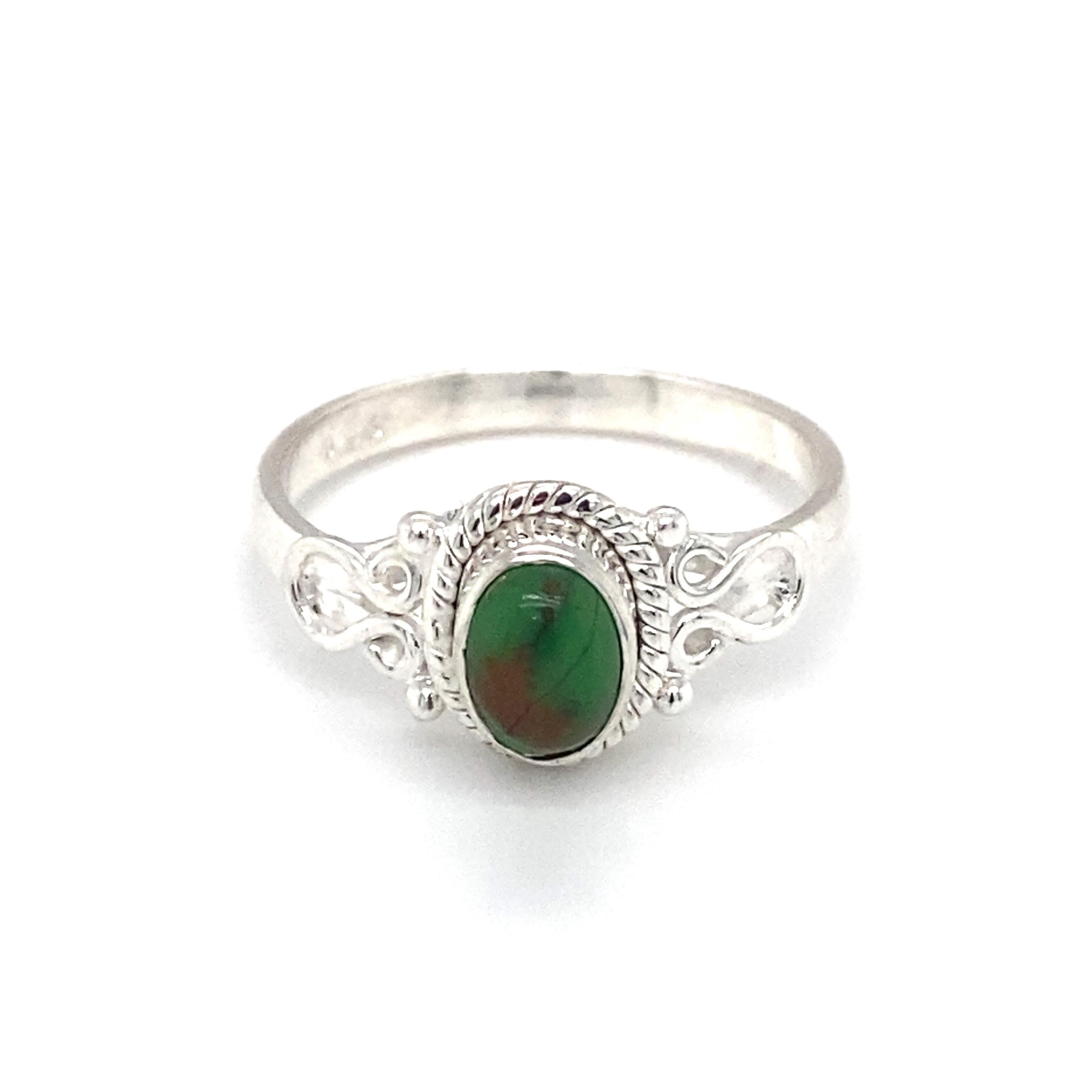 
Item Details: This southwestern-style ring has a center green turquoise with a rope bezel design and filigree on the sides.

Circa: 21st Century
Metal Type: Sterling silver
Weight: 3.2g
Size: US 9.5
