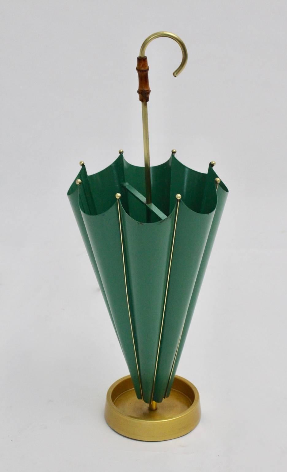 This charming umbrella stand was designed and produced in the 1950s, Italy. It is shaped like an umbrella and colored in green.
Furthermore the umbrella stand was made of cast iron, aluminium, sheet metal, brass and bamboo details.
The vintage