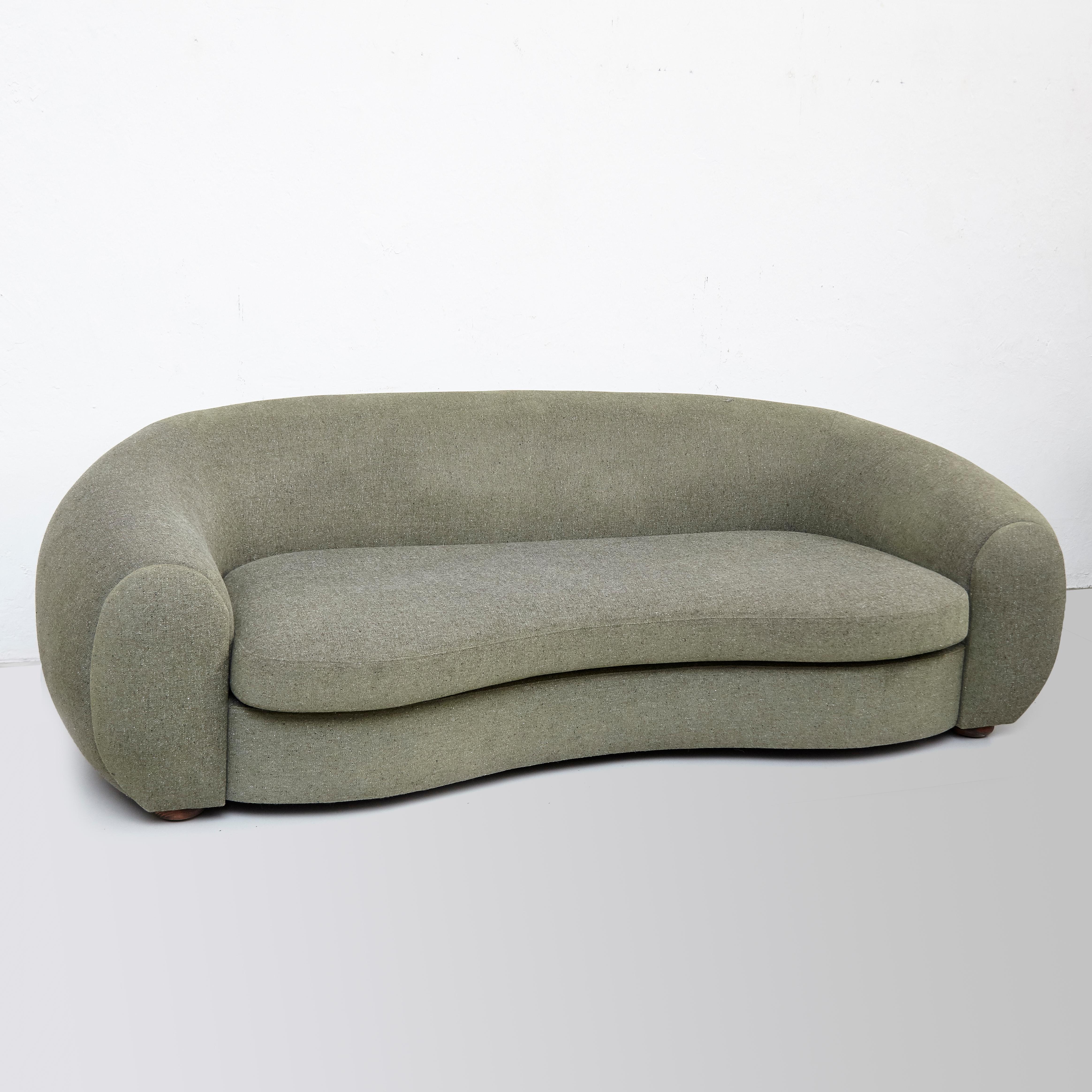 Green upholstered sofa 
Organic shape.
With refined upholstery.

In original condition, with wear consistent with age and use. It has a small break on on the fabric on on side.
It would definitely look great in any interior as it combines perfectly