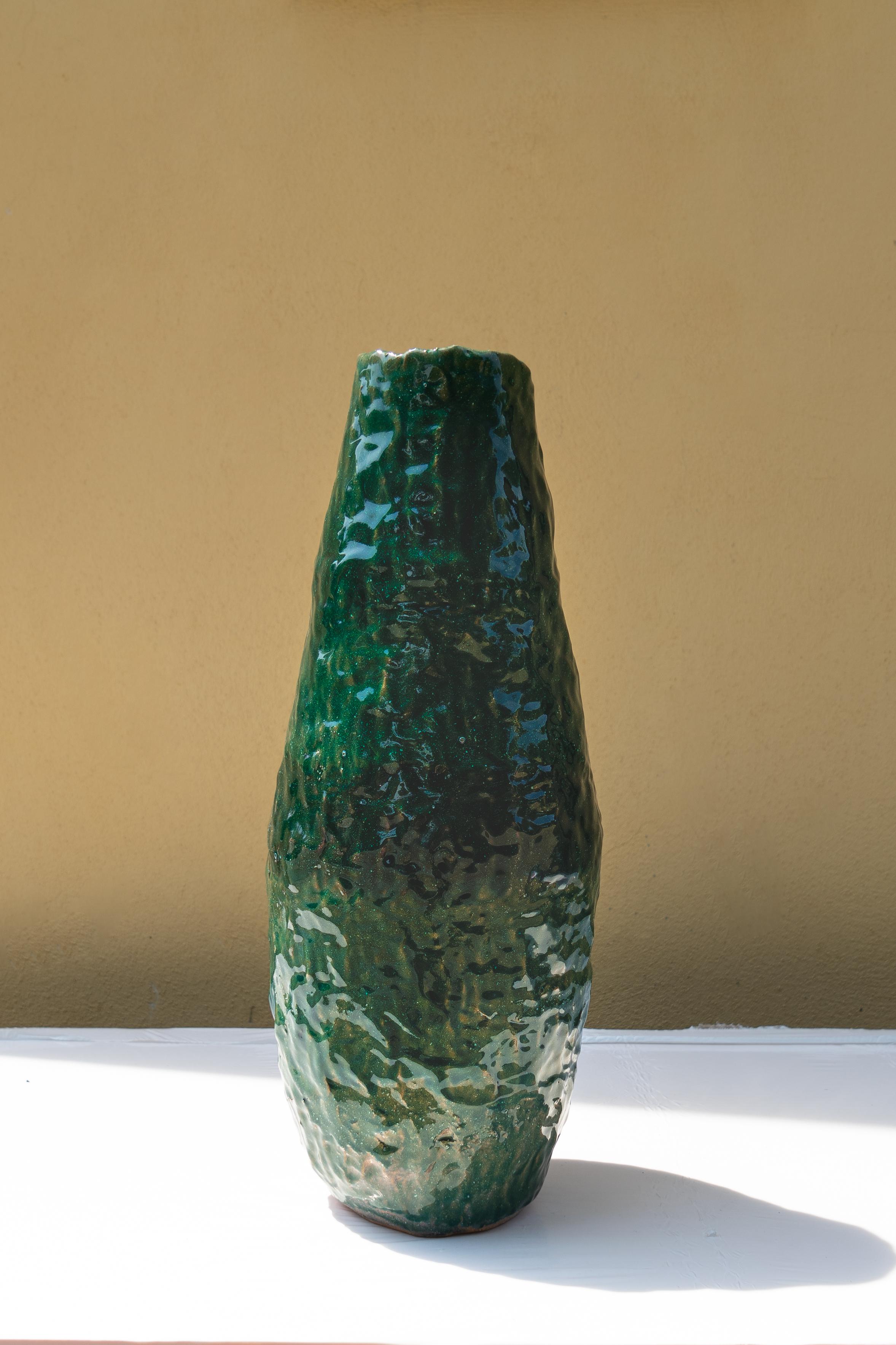Green vase by Daniele Giannetti
Dimensions: Ø 22 x H 52 cm.
Materials: glazed terracotta. 

All pieces are made in terracotta from Montelupo, only fired once, then colored by Daniele Giannetti with a white acrylic base, and then a mixture of