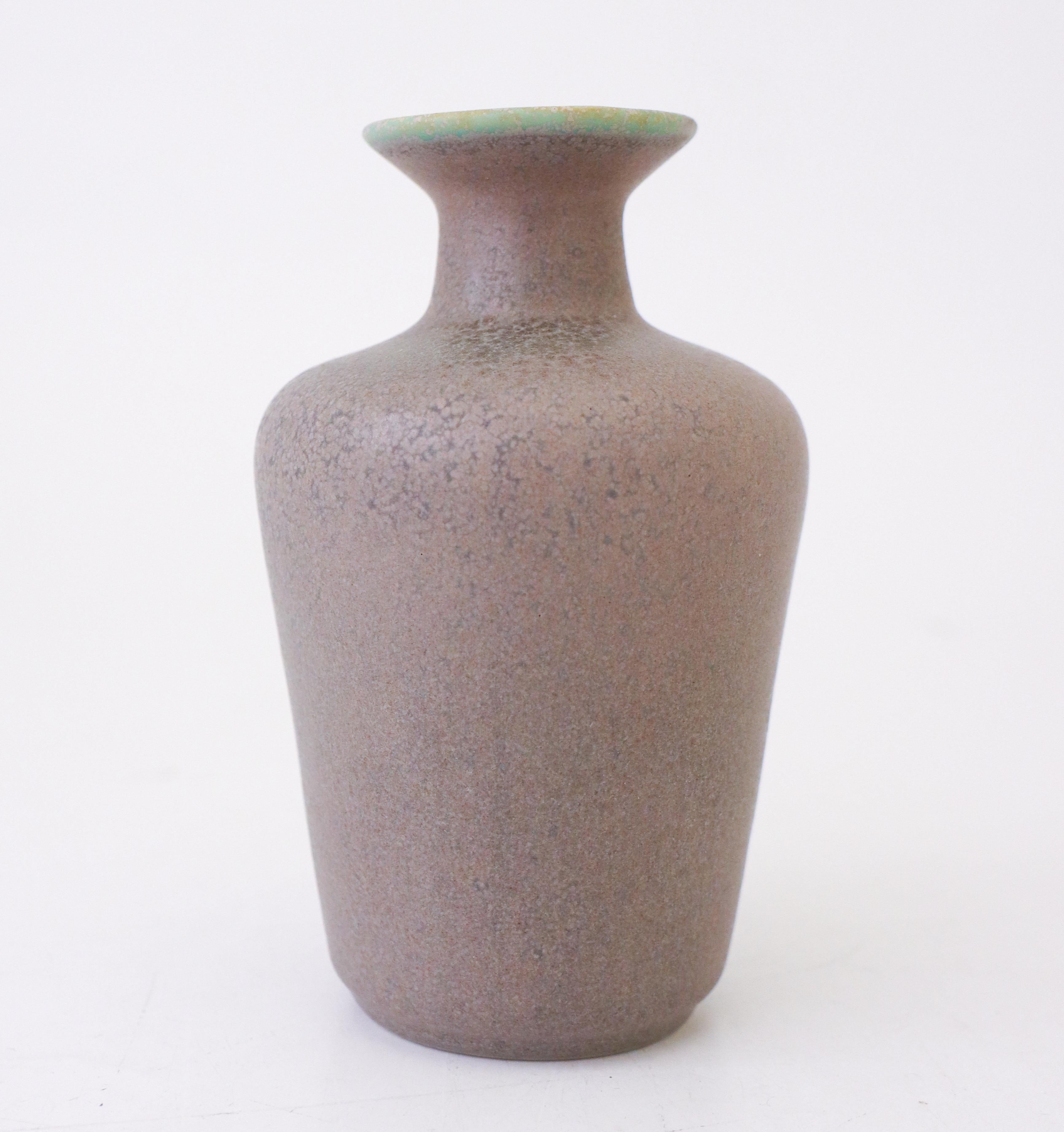 A vase with a lovely light-purple glaze designed by Gunnar Nylund at Rörstrand of model Granola, the vase is 14 cm (5.6