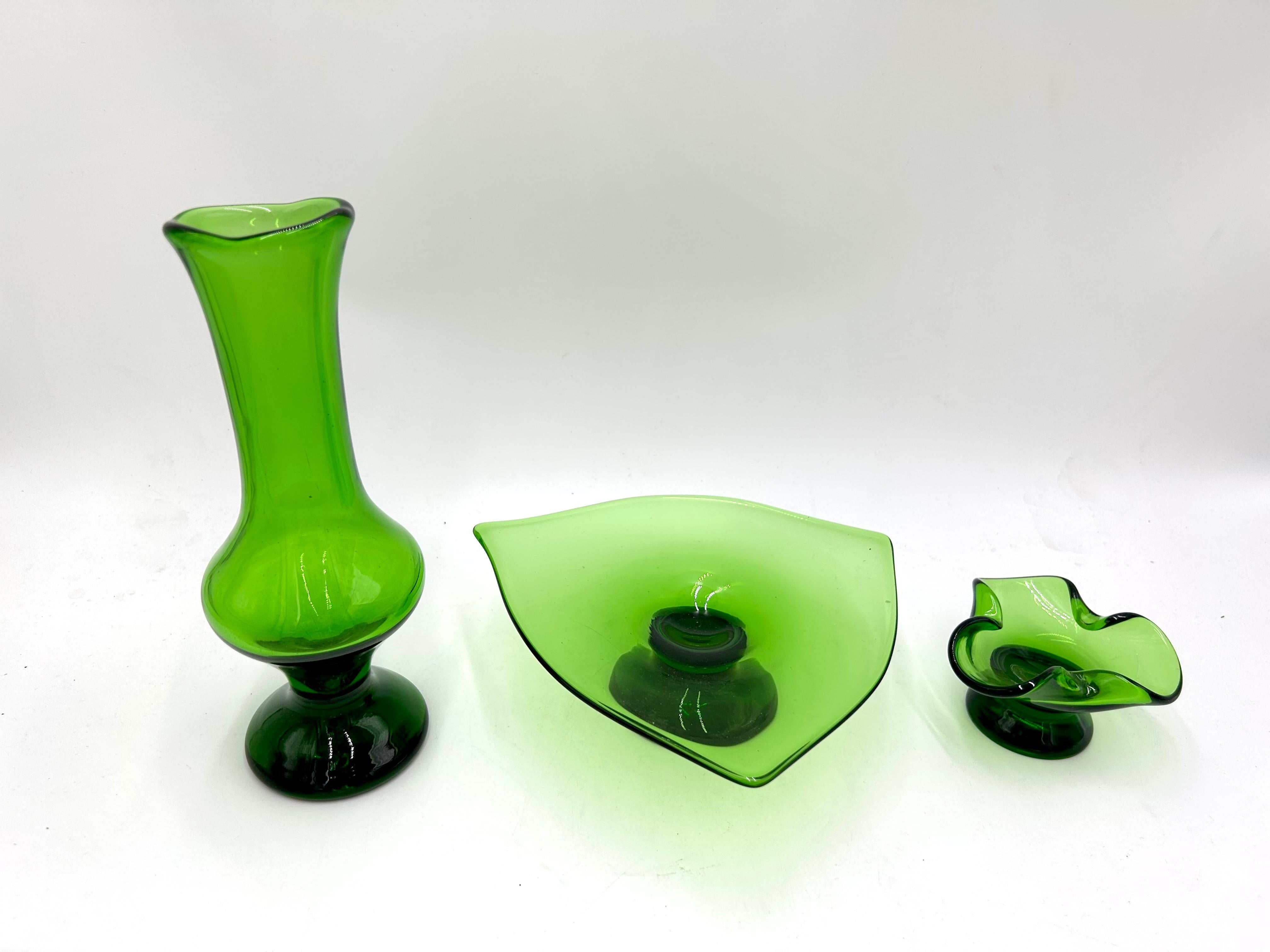 A green set of three glasses - a vase, a plate and an ashtray

Very good condition, no damage

Vase: height: 23cm, diameter: 7cm

Plate: height 6cm, width 20cm

Ashtray: height 5.5 cm, width 10 cm.