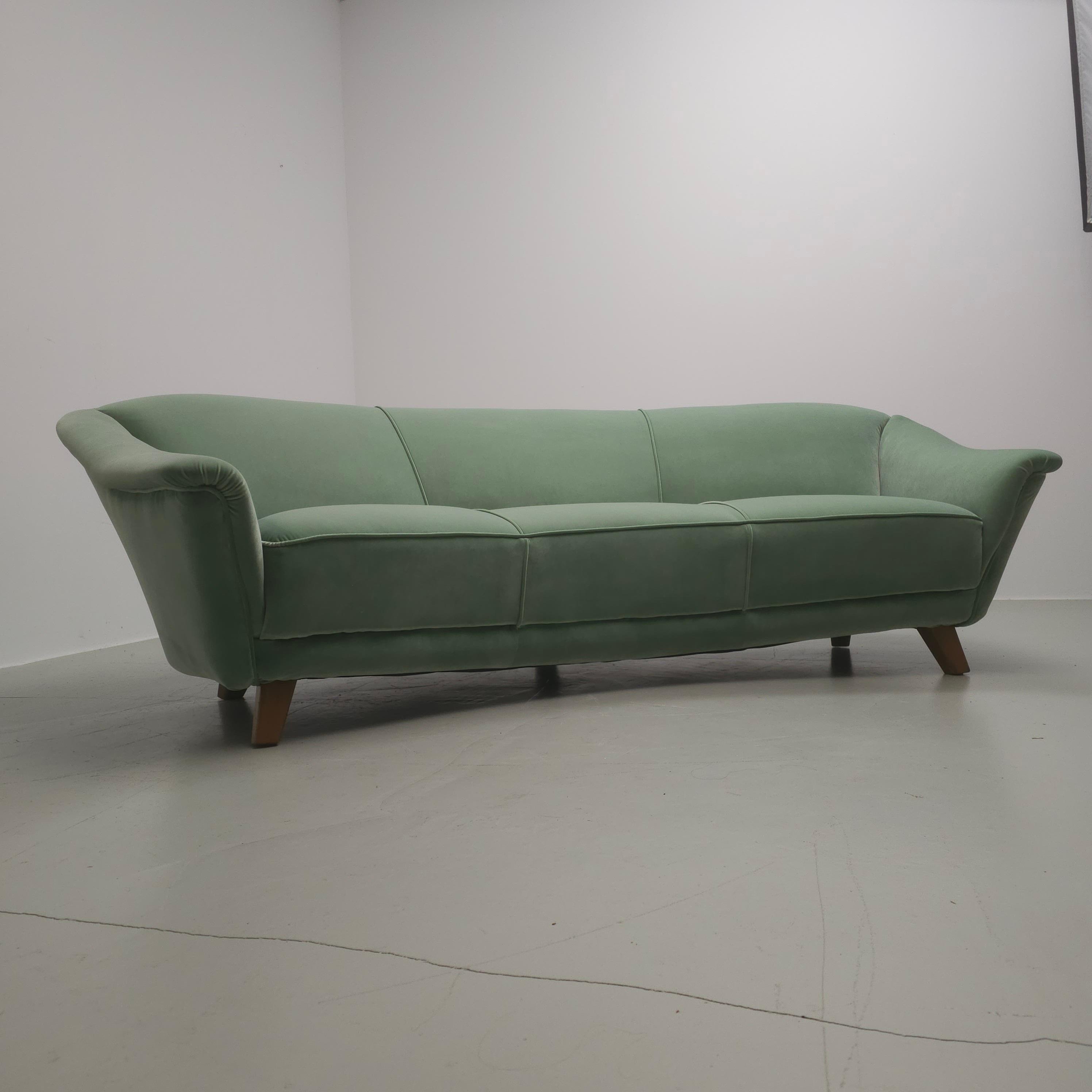 'Banana' shape, 50's couch. Newly reupholstered in a green color, velvet fabric. The back and seating have new foam.
As a square the couch is measured W230xD116xH76cm. As the shape is like a banana it is W230xD90xH76cm.
If you like the sofa but need