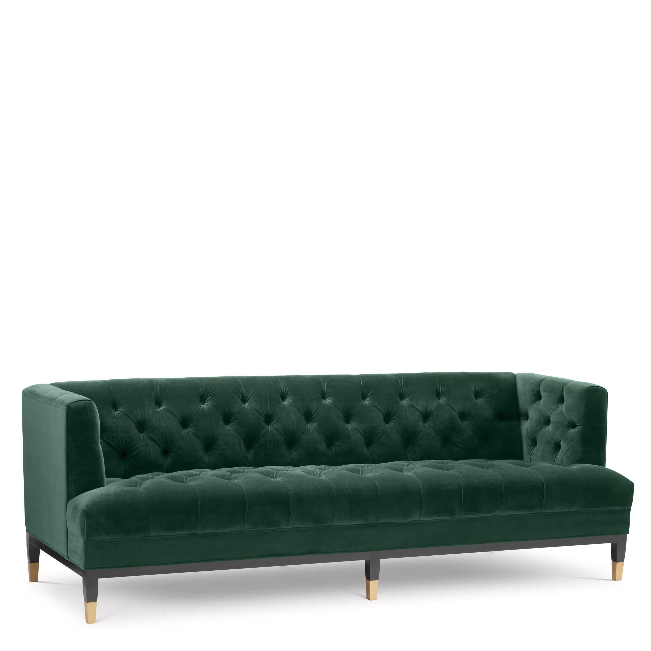 Black lacquered wooden feet and deep green velvet colored comfy Chesterfield style sofa