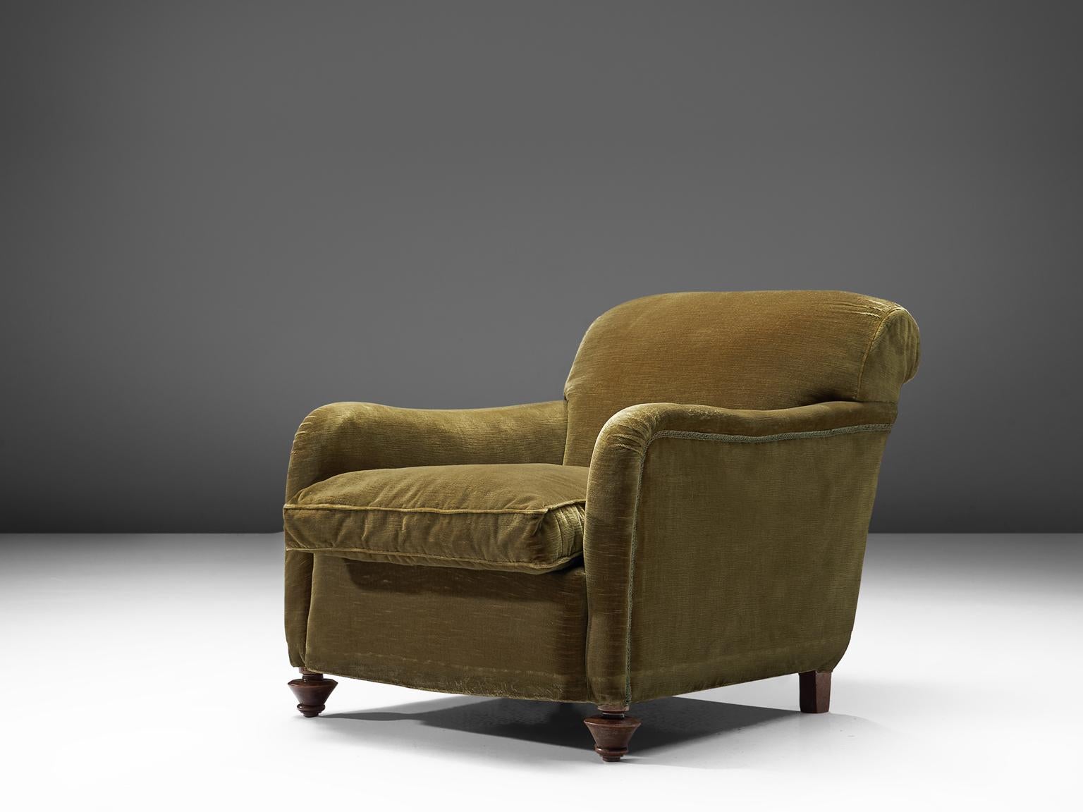 Lounge chair, green velvet fabric, Italy, 1940s. 

Wide and comfortable chair in green velvet fabric upholstery. Truly extraordinary lounge chair that features a very deep seat and cornered curved armrests. This piece is very comfortable due to