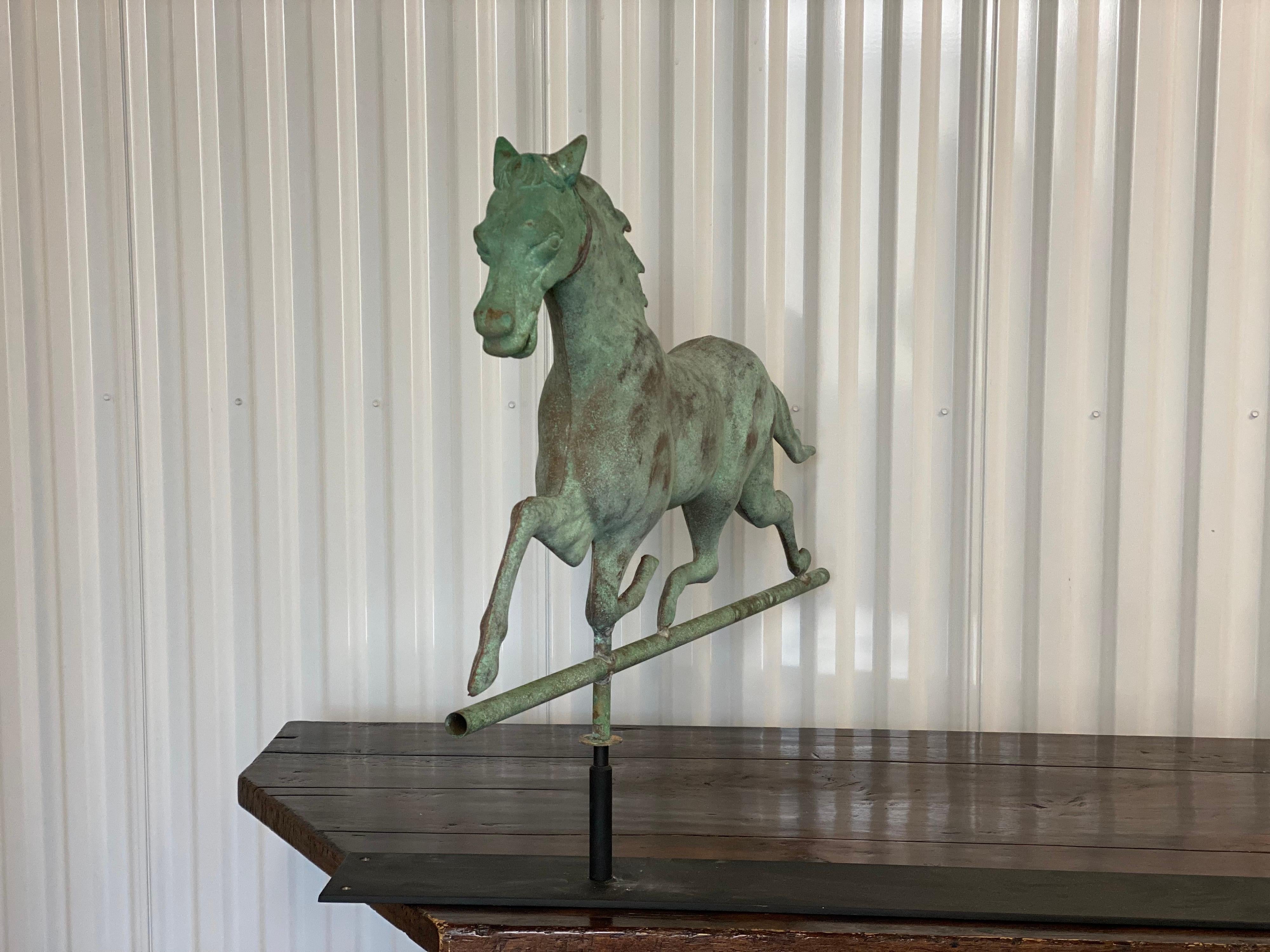 Green Verdigris Horse Weathervane on stand, Attributed to Ethan Allen.
A beautifully patinated verdigris iron running horse weathervase from the 19th century, attributed to Ethan Allen. On custom iron stand.

34
