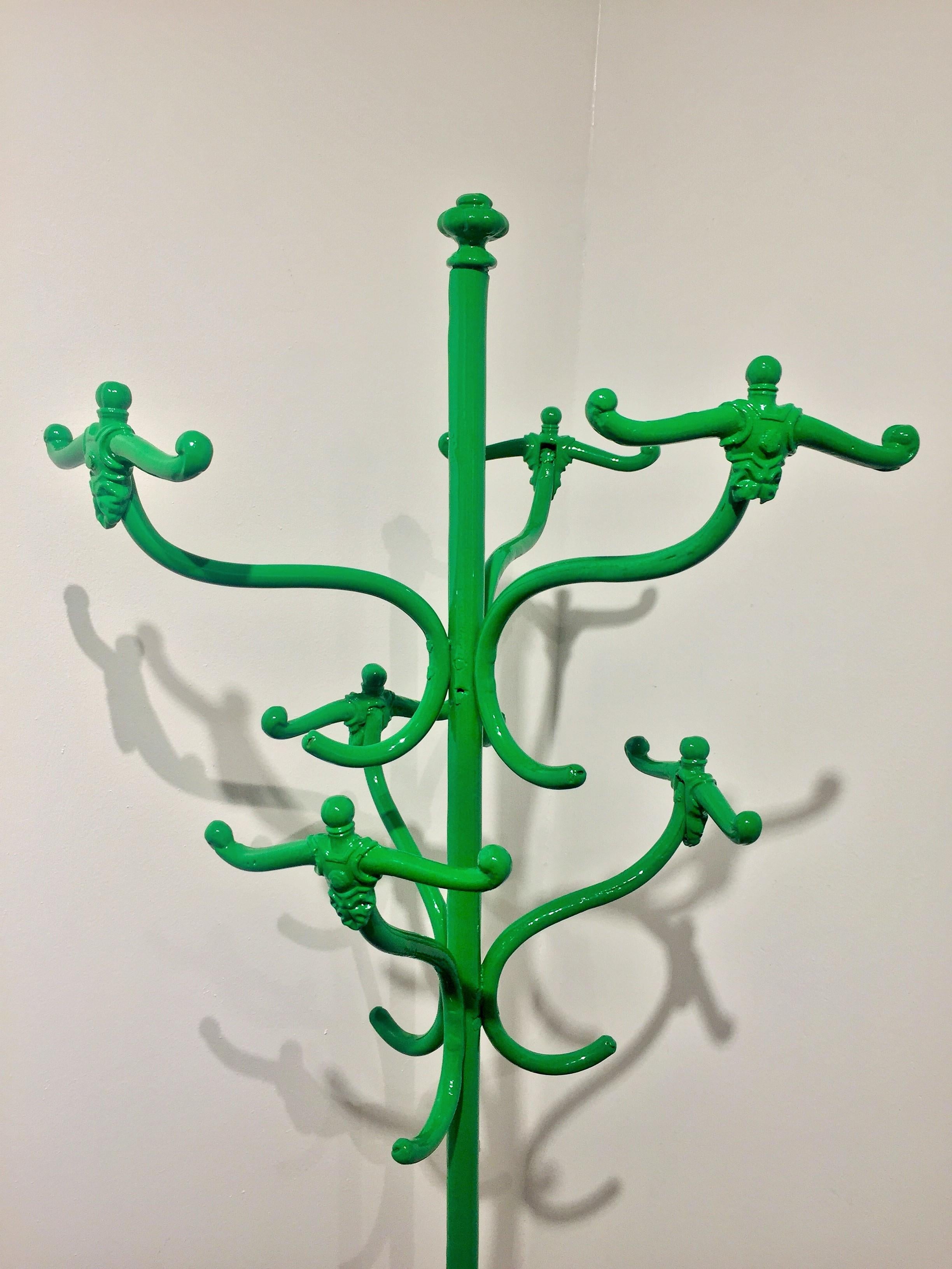 Vintage coat rack, powder coated in bright green. Six hooks resembling a swimmer prior to diving, make this a cheerful functional item. Though we also like it as an art piece. The coat rack shows minor wear throughout, with the most visible wear