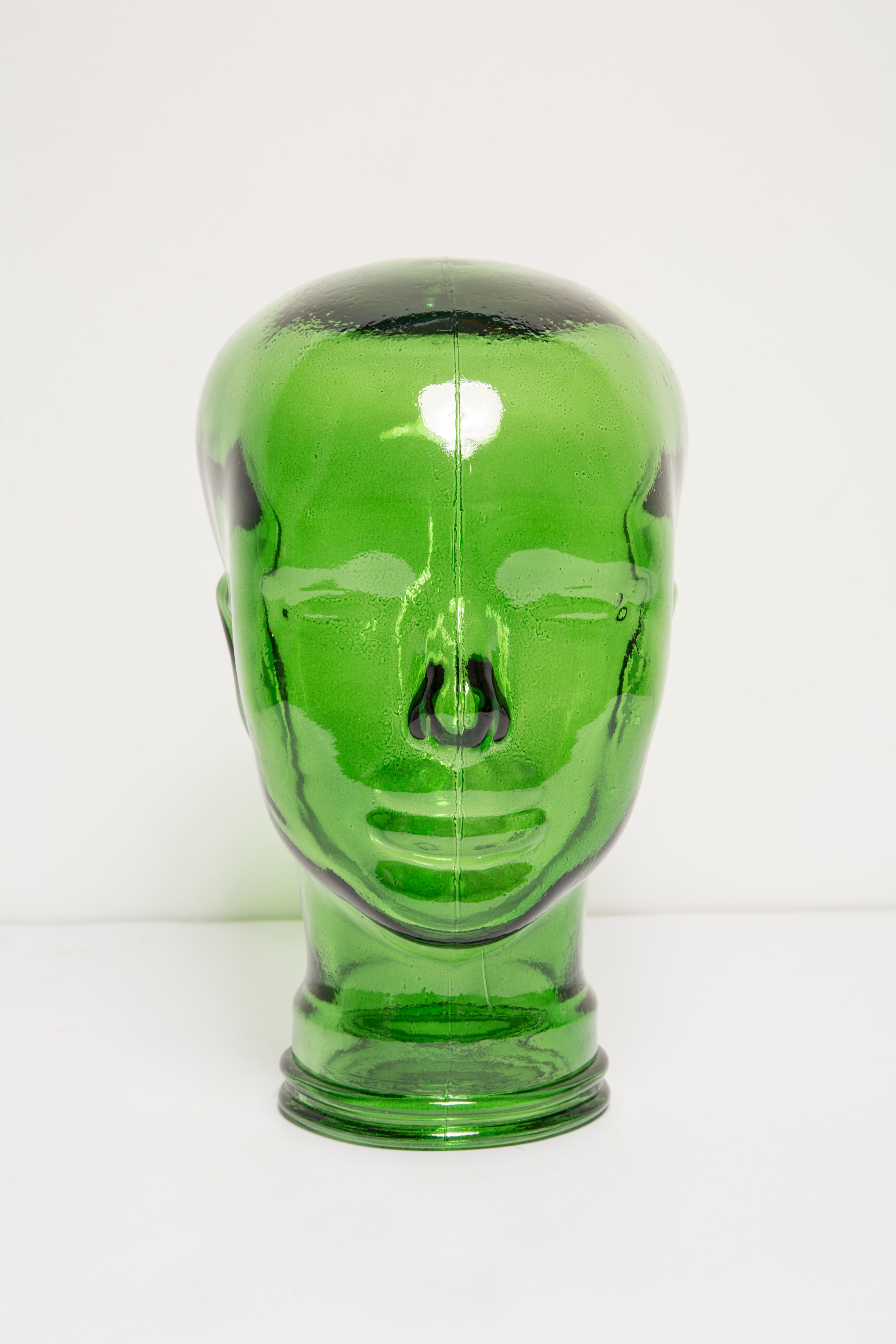 Life-size glass head in a unique green color. Produced in a German steelworks in the 1970s. Perfect condition. A perfect addition to the interior, photo prop, display or headphone stand.