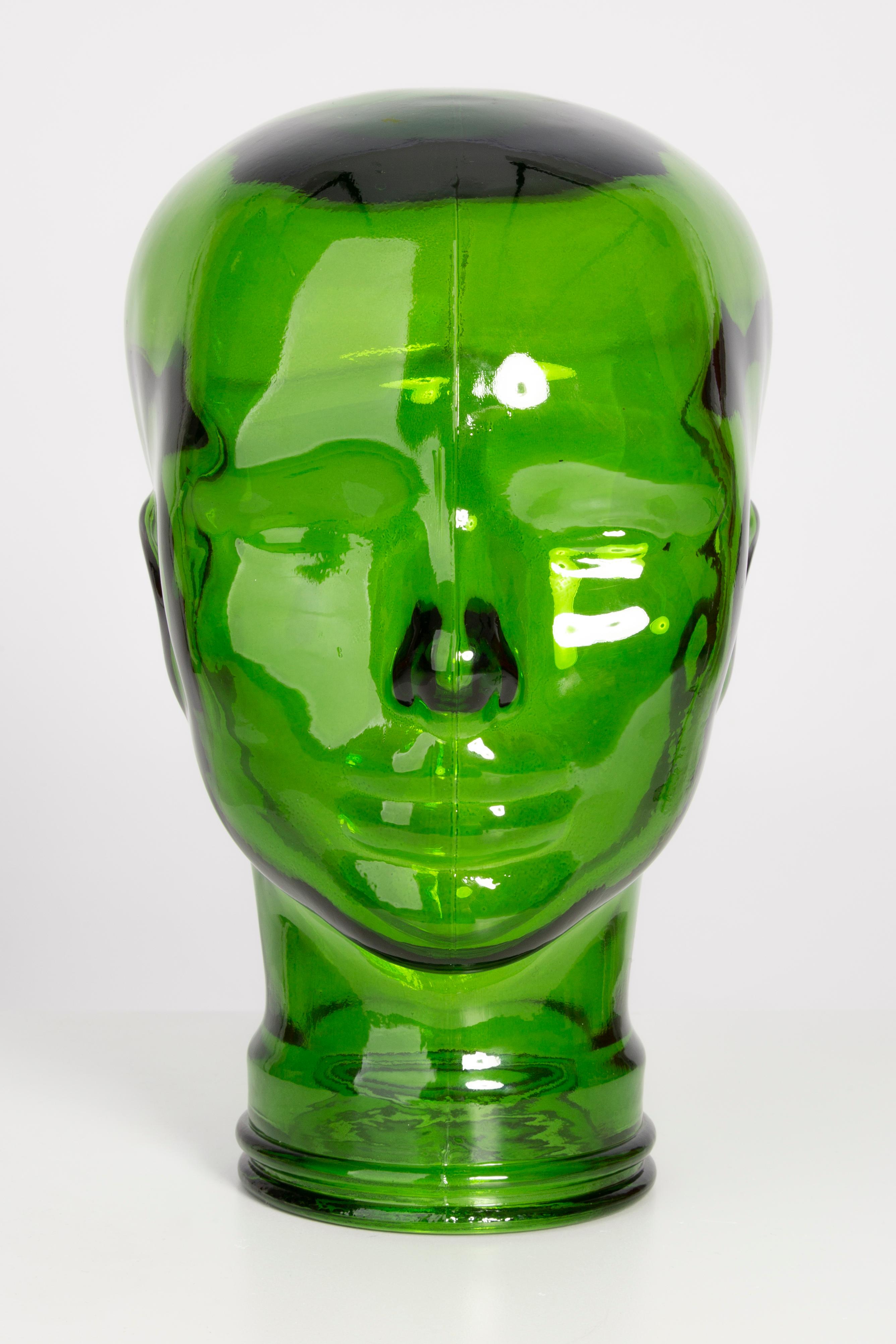 Life-size glass head in a unique deep green color. Produced in a German steelworks in the 1970s. Perfect condition. A perfect addition to the interior, photo prop, display or headphone stand.