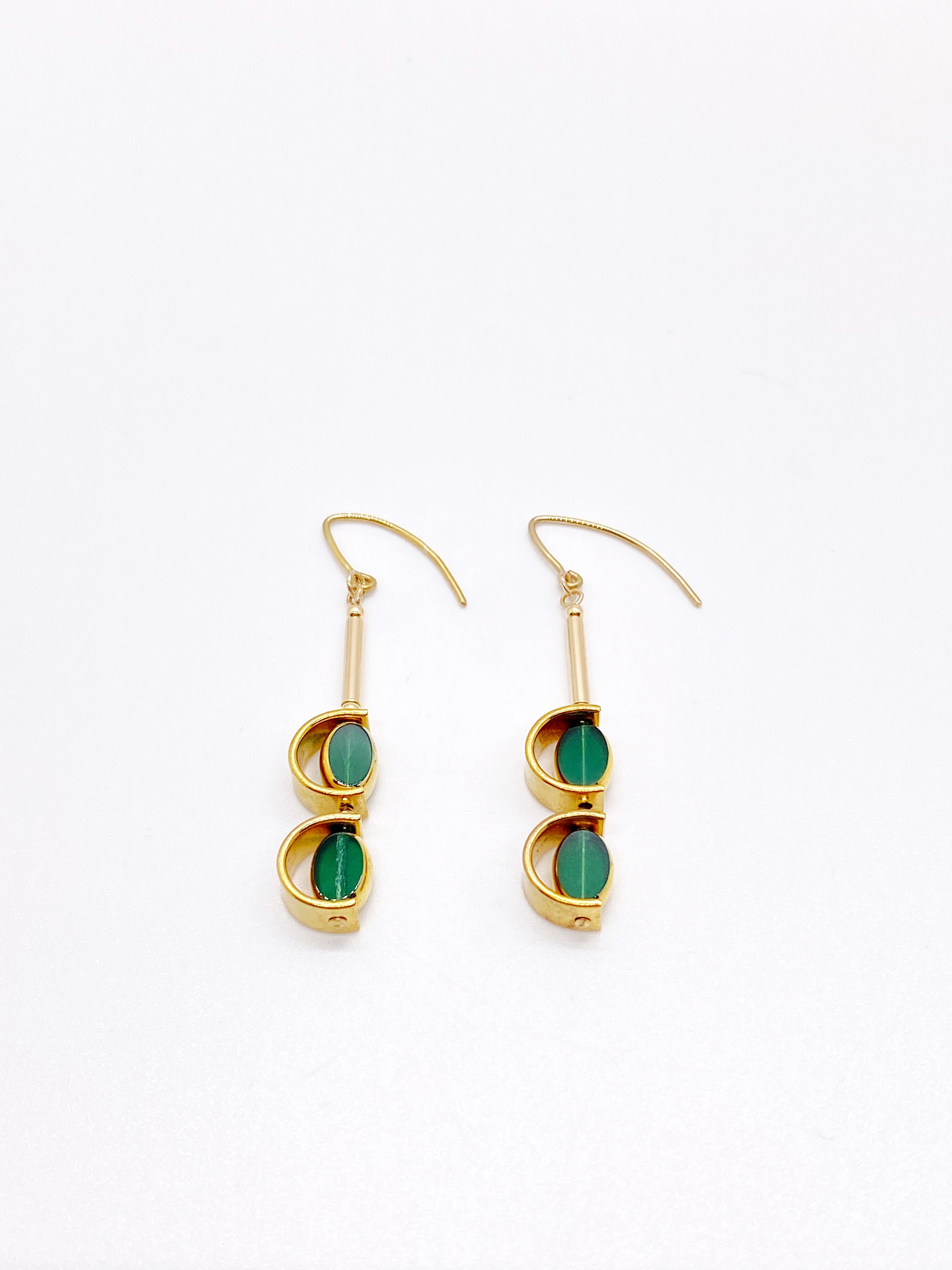 This is for a set of earrings. The earrings consist of 2 mini emerald  green oval shaped beads. They are new old stock vintage German glass beads that are framed with 24K gold. The beads were hand pressed during the 1920s-1960s. No two beads are
