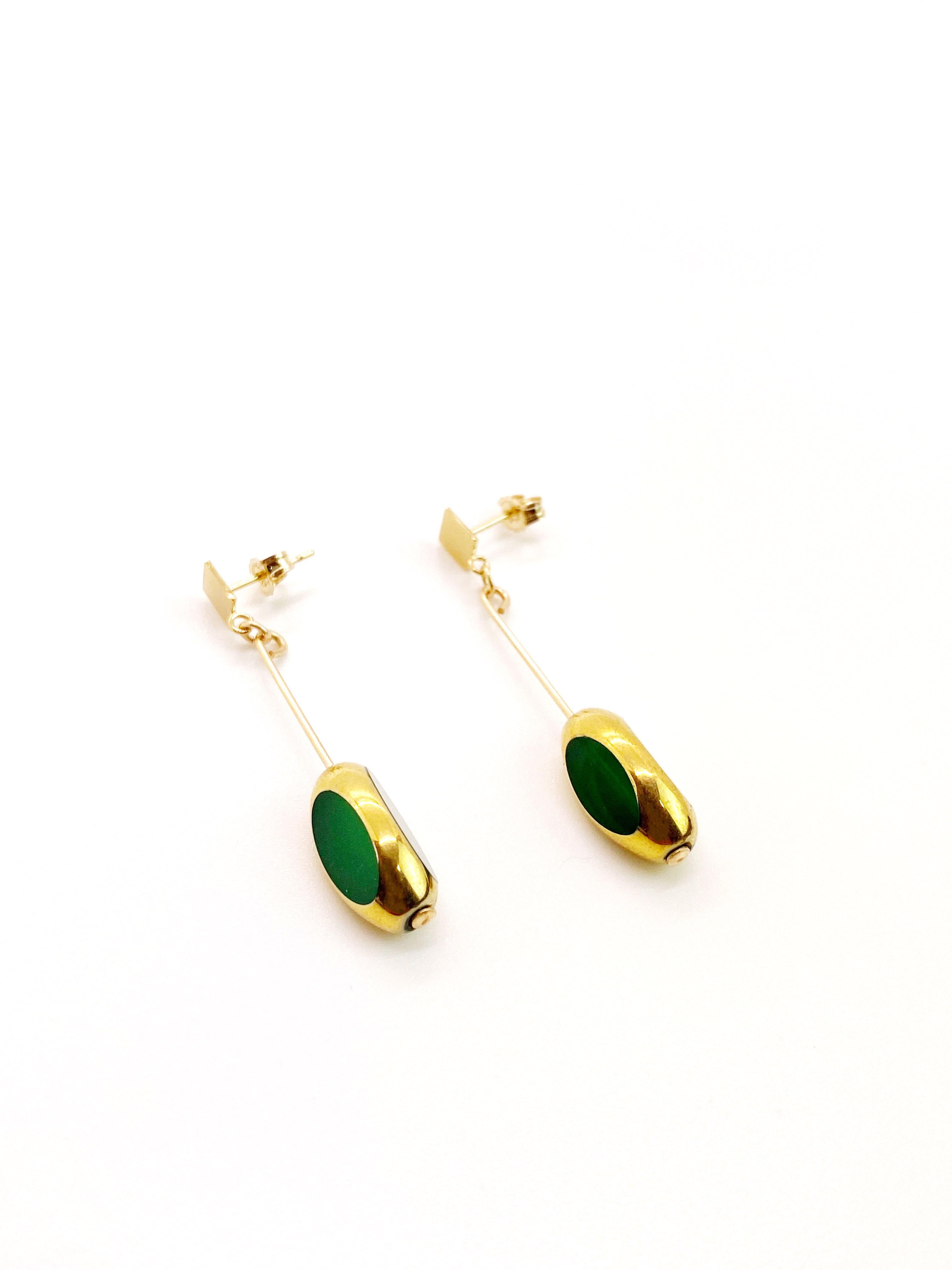 Green vintage German glass window beads edged with 24K gold dangles on a 14K gold filled ear wire. 

The German vintage glass beads are considered rare and collectible, circa 1920s-1960s.