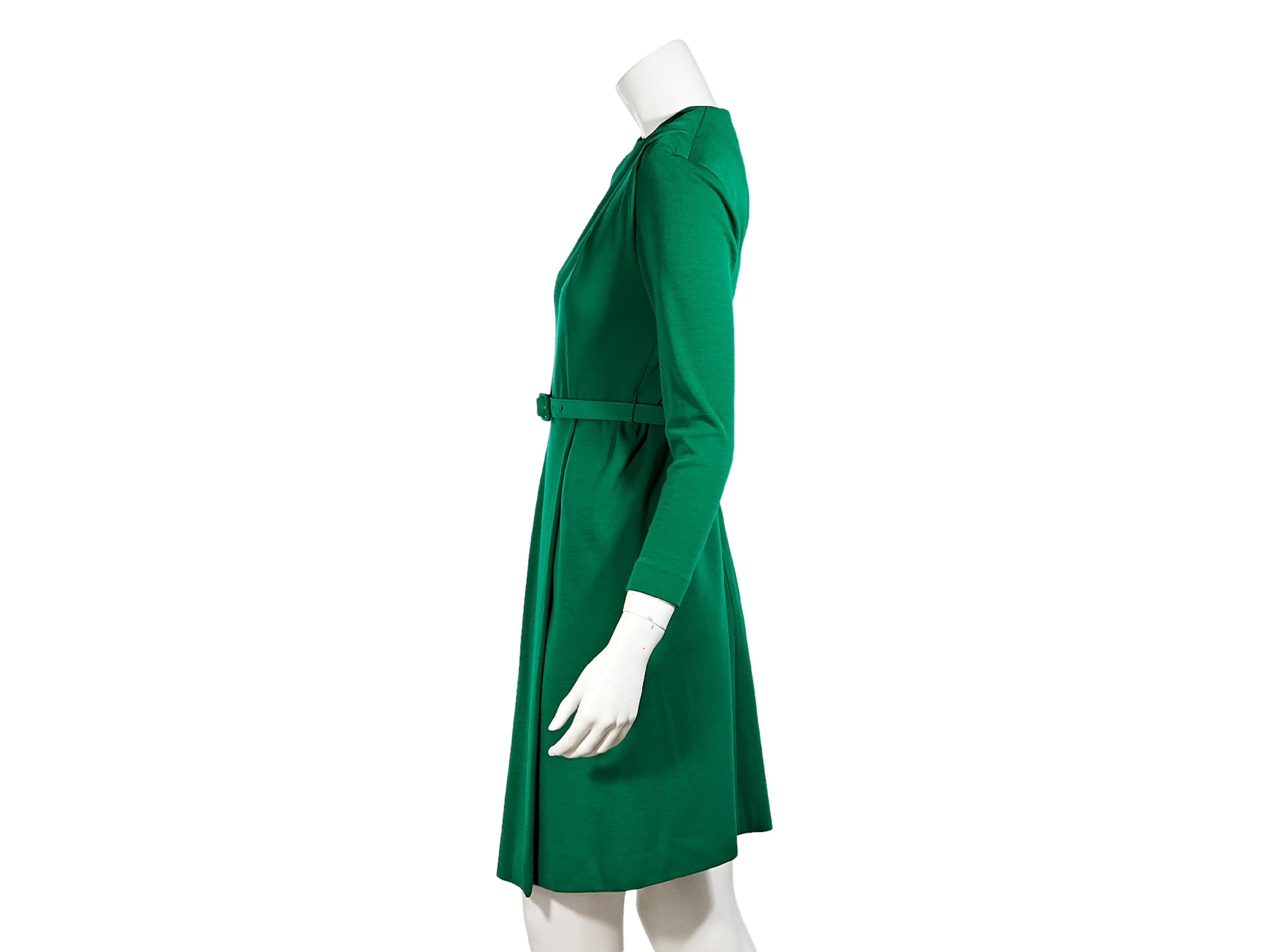 Product details:  Vintage green wool belted dress by Givenchy.  Circa the early 1980s.  Crewneck.  Bracelet-length sleeves.  Pleats taper off shoulder.  Adjustable belted waist.  Concealed back zip closure. 34