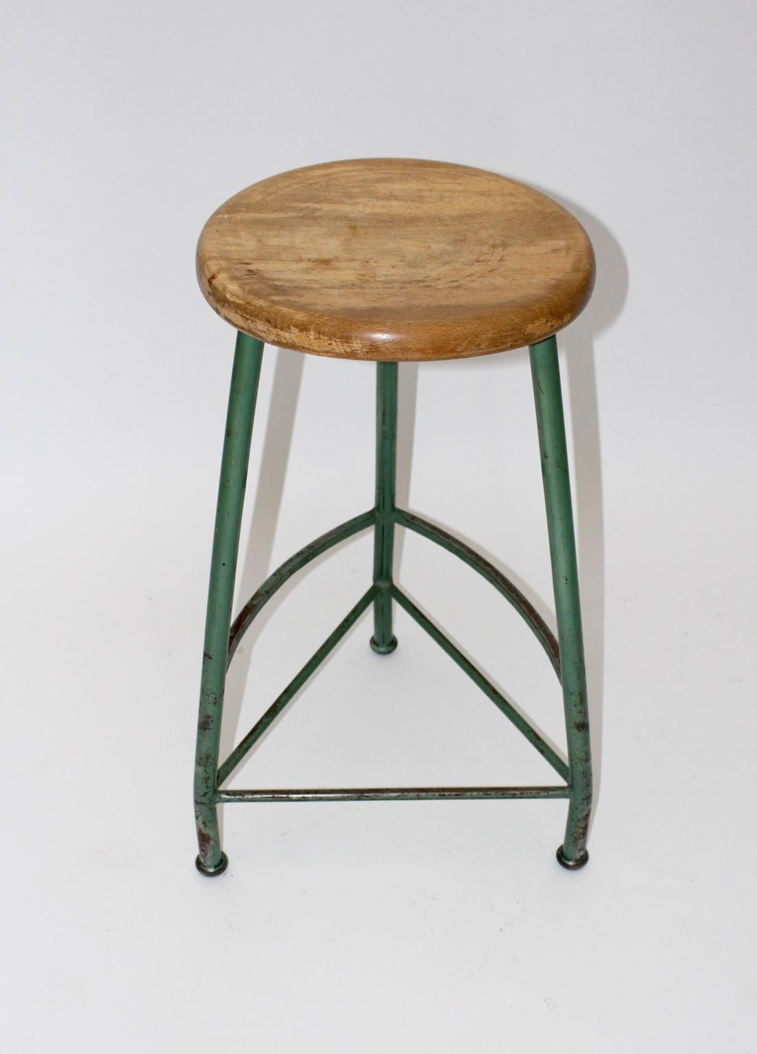 This tripod Industrial stool came from the Kromus Factory in Vienna 1950s.
The stable stool was made of tabular steel, green lacquered and a solid beechwood seat.
The vintage condition is very good with the beloved signs of age and use.

Lit.: