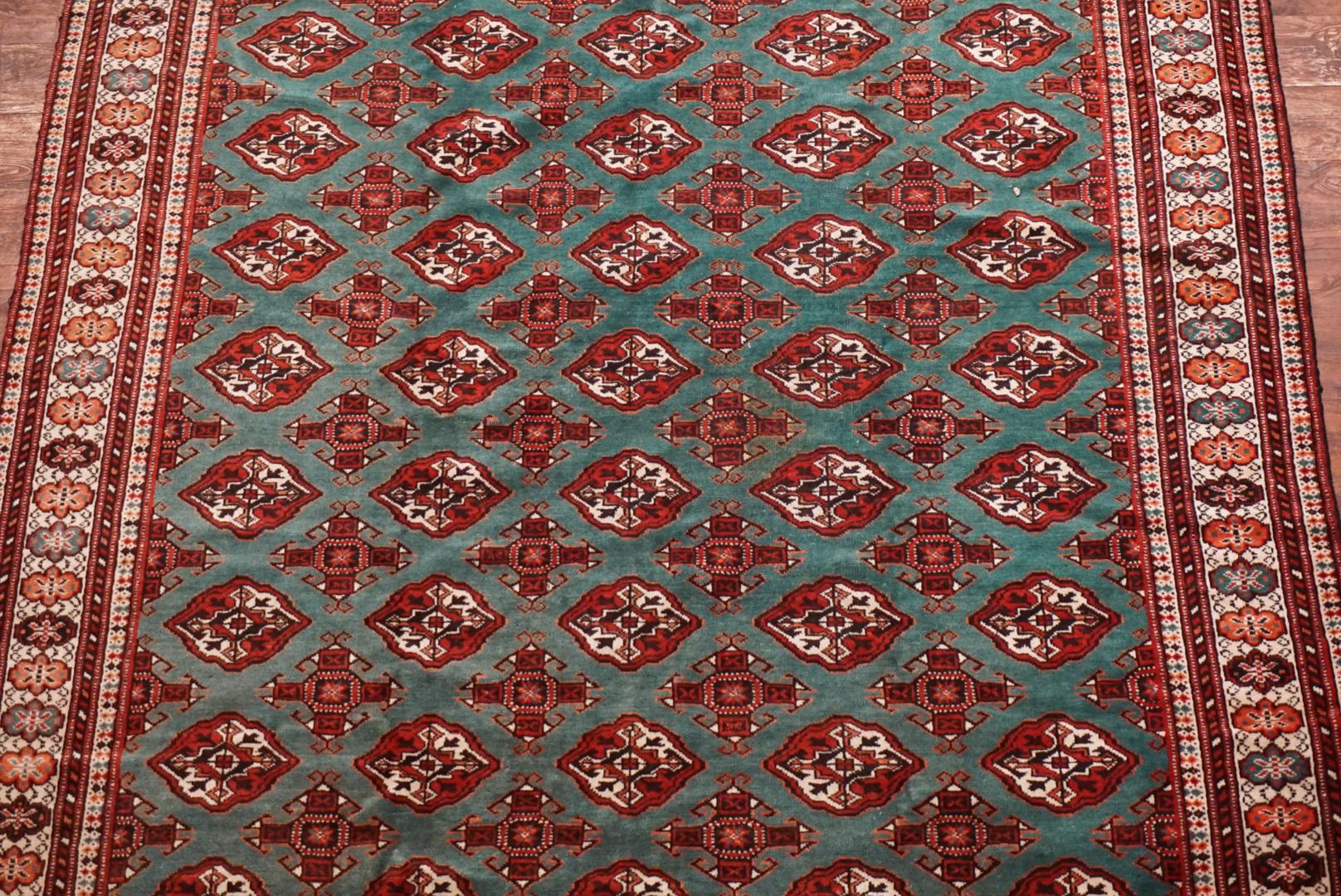 Green Vintage Pak Bukhara rug,

circa 1970

Measures: 6' 6