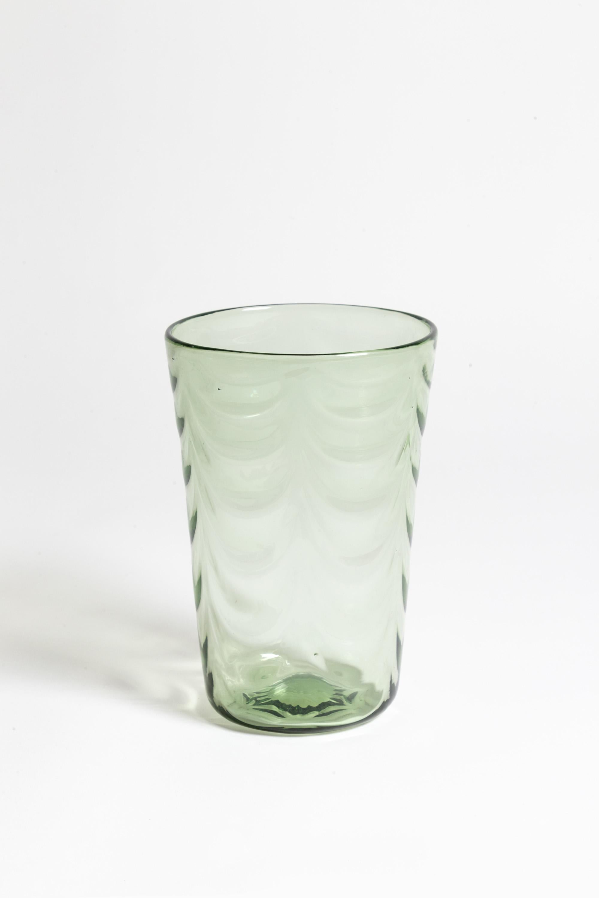 A Sea Green Whitefriars glass wave vase designed by Marriot Powell c.1930.

Design no. 8437.

Good overall condition with no chips or scratches to the body of the vase. Minor scuffing to the base commensurate with age and use.