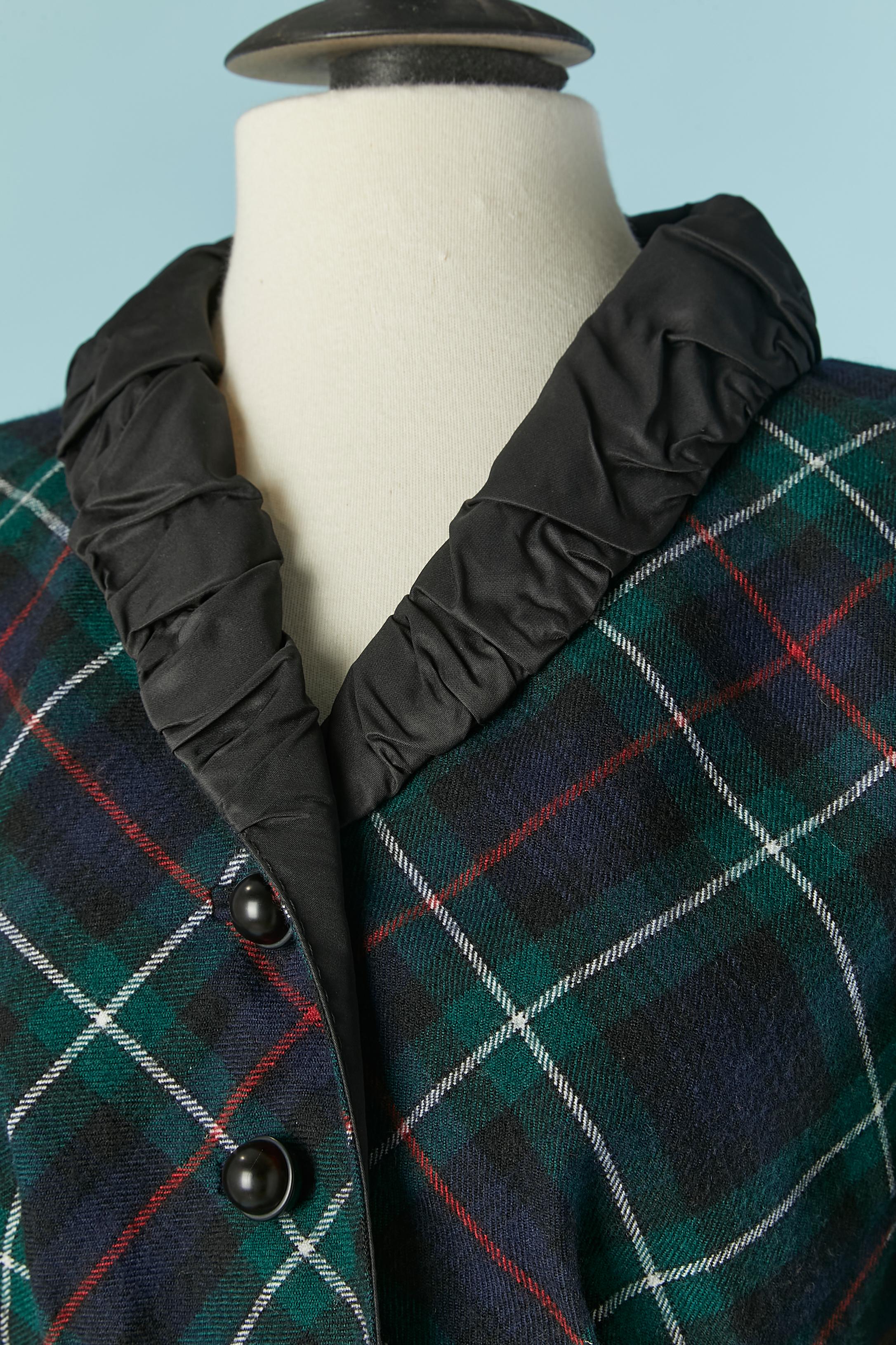Green wool Tartan single breasted jacket with taffetas collar. Branded body lining composition: 100% silk. Sleeve lining composition: 100% rayon. Pocket on both side. Button and buttonhole closure on the middle front + on cuffs. Cut-work and smocks