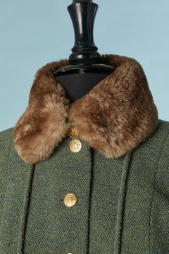 Green wool tweed skirt suit with gold buttons and fur pompoms Chanel Boutique