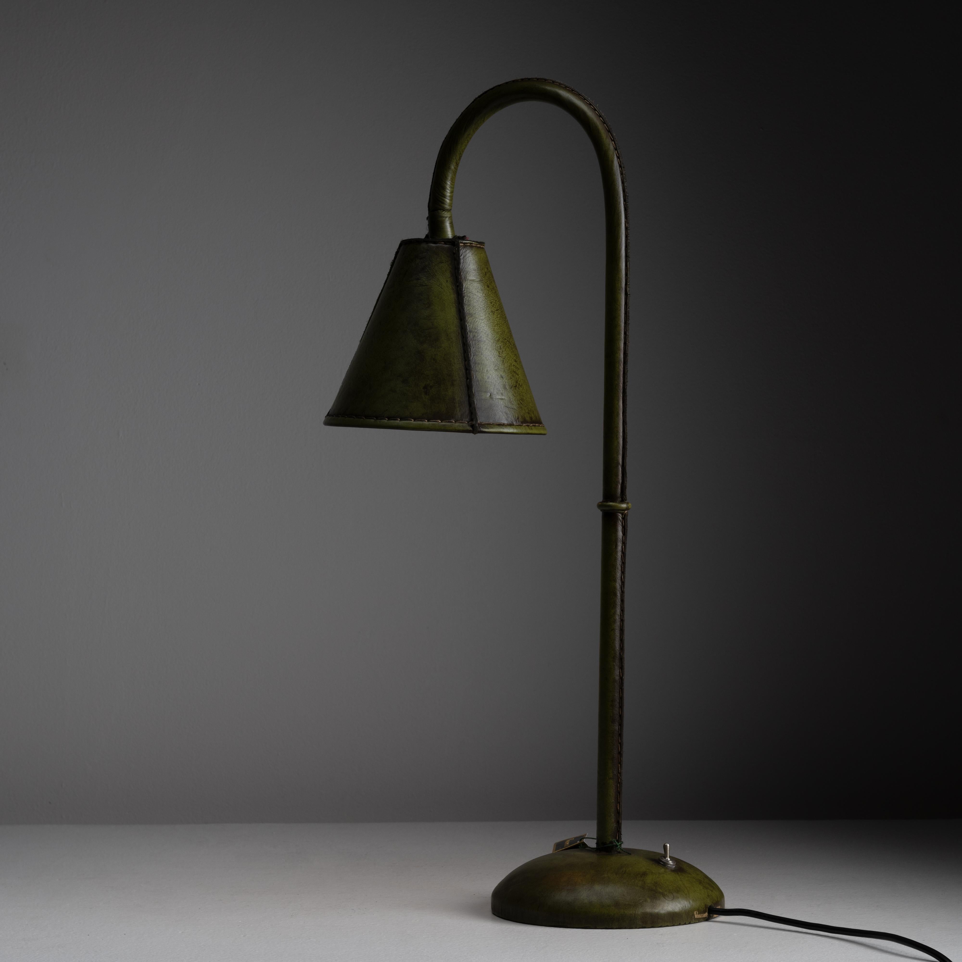 Green wrapped leather table lamp by Valenti. Designed and manufactured in Spain, circa the 1970s. Purchased as dead stock. Fully wrapped leather table lamps with a shade that swivels. On and off toggle switch at the base. Holds one E27 socket type,