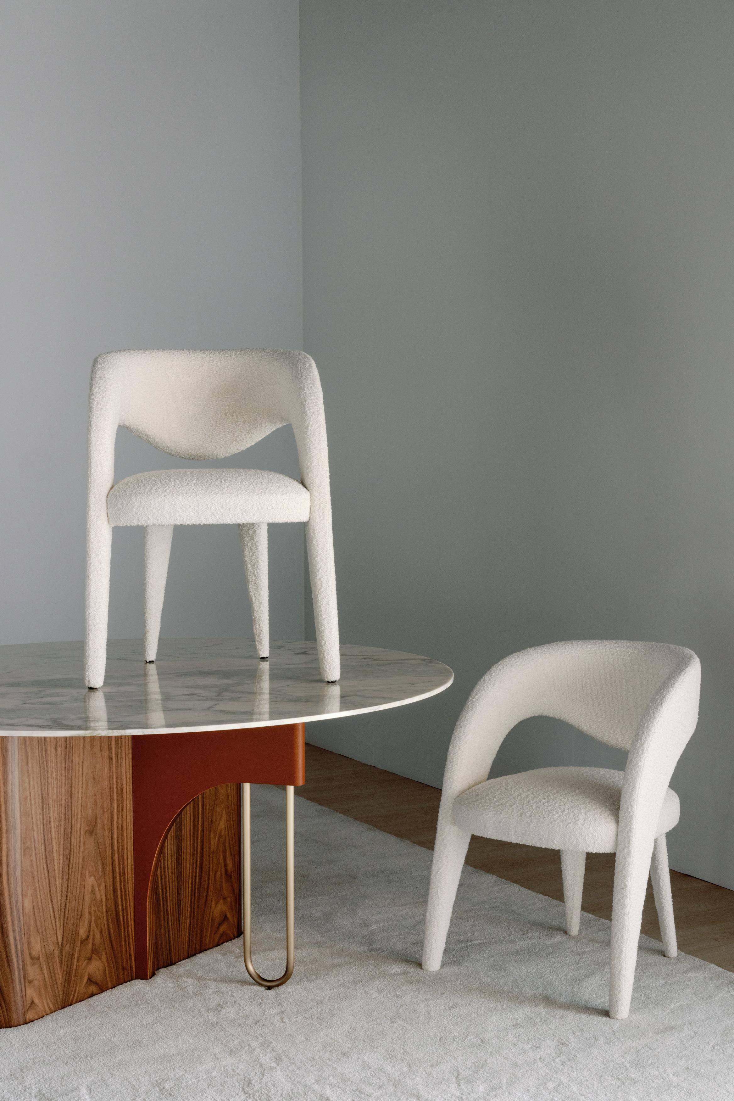 Laurence Chair, Contemporary Collection, Handcrafted in Portugal - Europe by Greenapple.

Designed by Rute Martins for the Contemporary Collection, the Laurence bouclé dining chair was created with the artistic intent of reimagining the image of