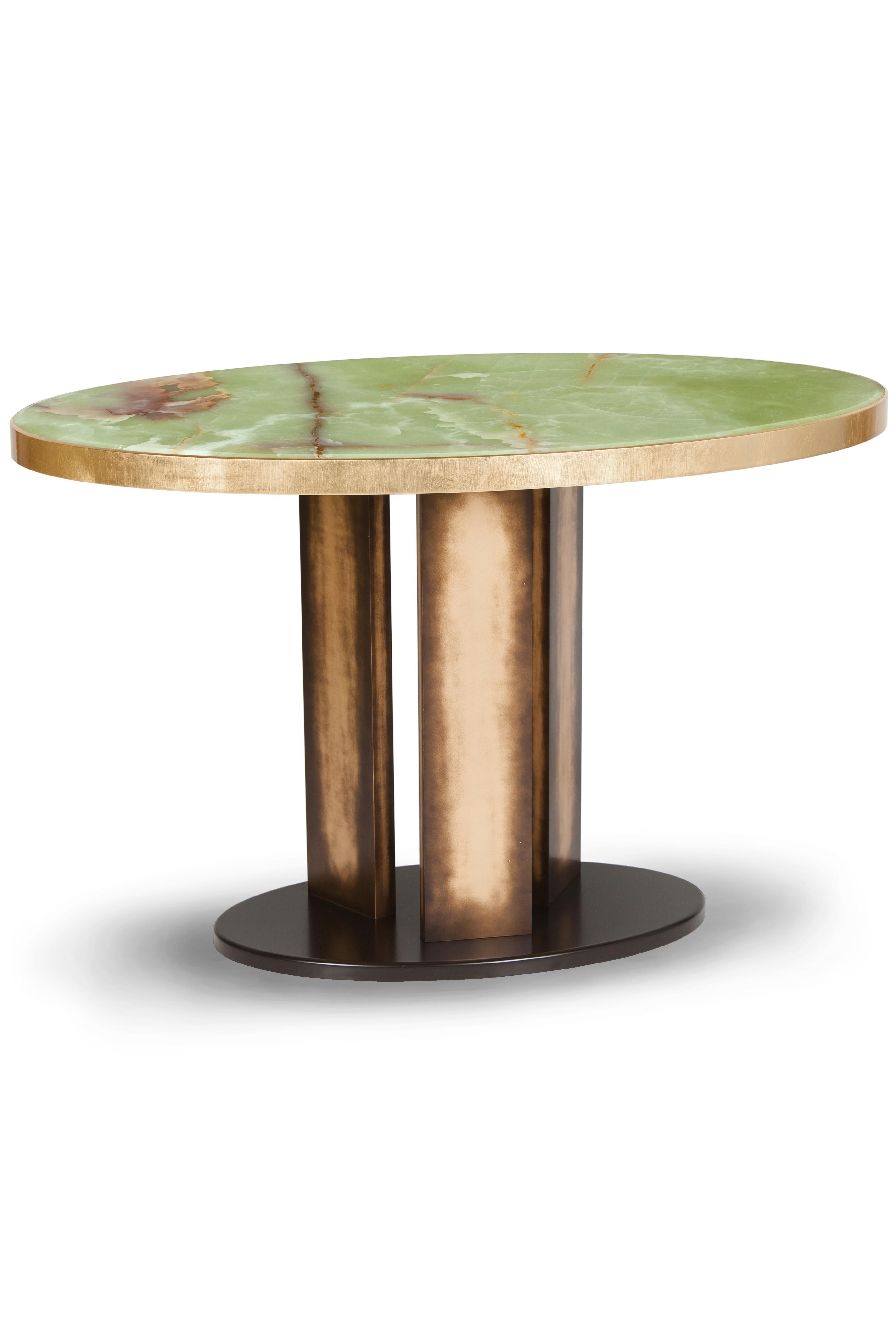 Balu dining table, Contemporary Collection, Handcrafted in Portugal - Europe by Greenapple.

Ball was designed to be the centrepiece of any dining interior. The combination between the stunning Green Onyx and the brown-gold bronze legs leaves no one